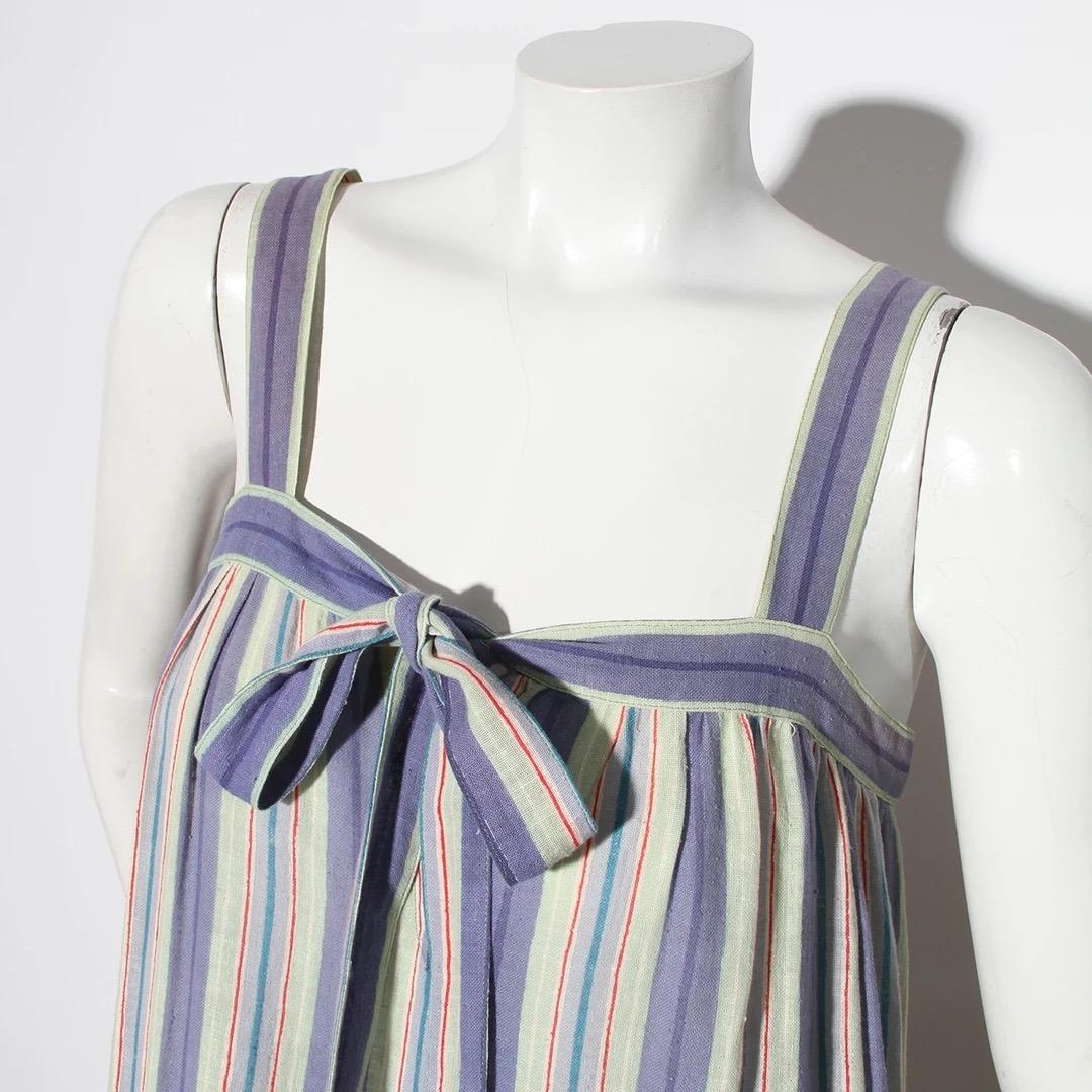 Saint Laurent Rive Gauche Dress
Vintage 
Circa 1980's 
Made in France 
Blue, Green, red and white stripe pattern 
Wide tank style straps 
Drop waist silhouette 
Bow in front of dress at bustling 
Square neckline 
Keyhole detail at bust 
Pleat
