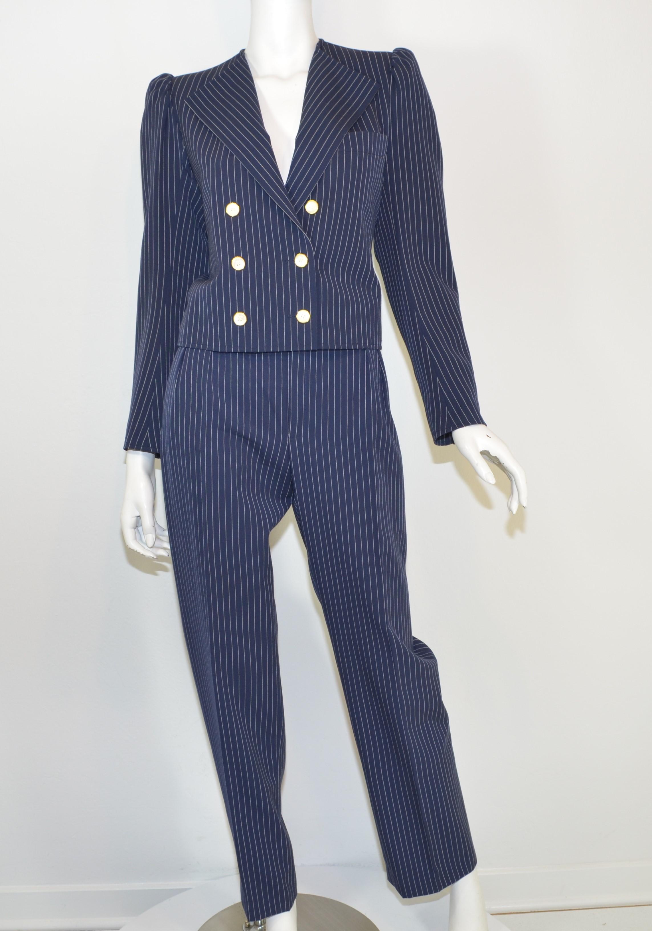 Saint Laurent Vintage Navy Striped Pant + Jacket Suit Set -- Suit is featured in navy blue with white pinstripes. Jacket has opalescent button closures along the front and on the cuffs. Pants have a button and zipper fastening. Pants and jacket are