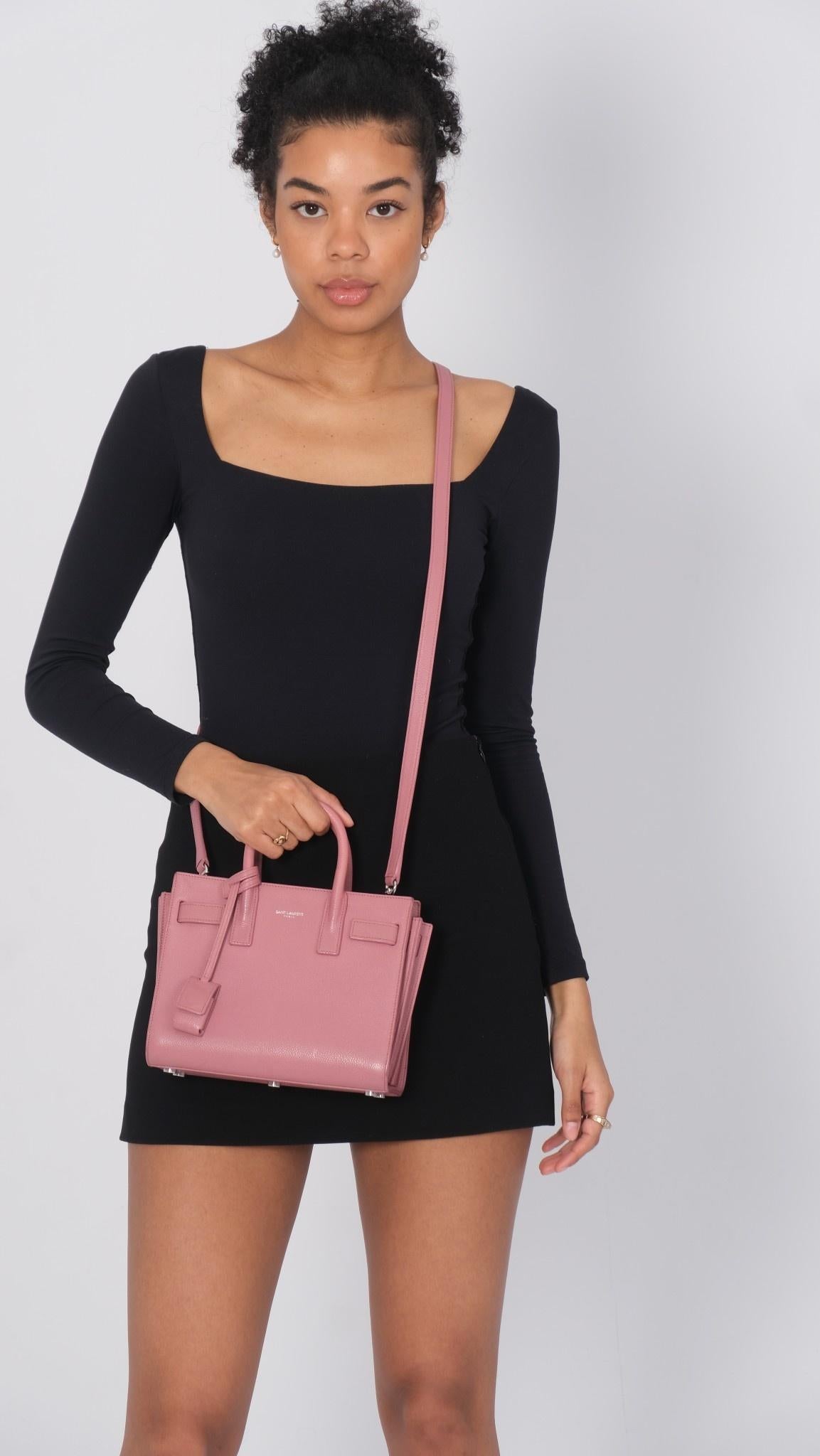 This structured mini tote is mae of smooth calfskin leather in rose pink. The bag features accordion style sides and rolled leather top handles. The top of this petite handbag opens to a compact black fabric interior.
Retail
 
Color: Rose / light