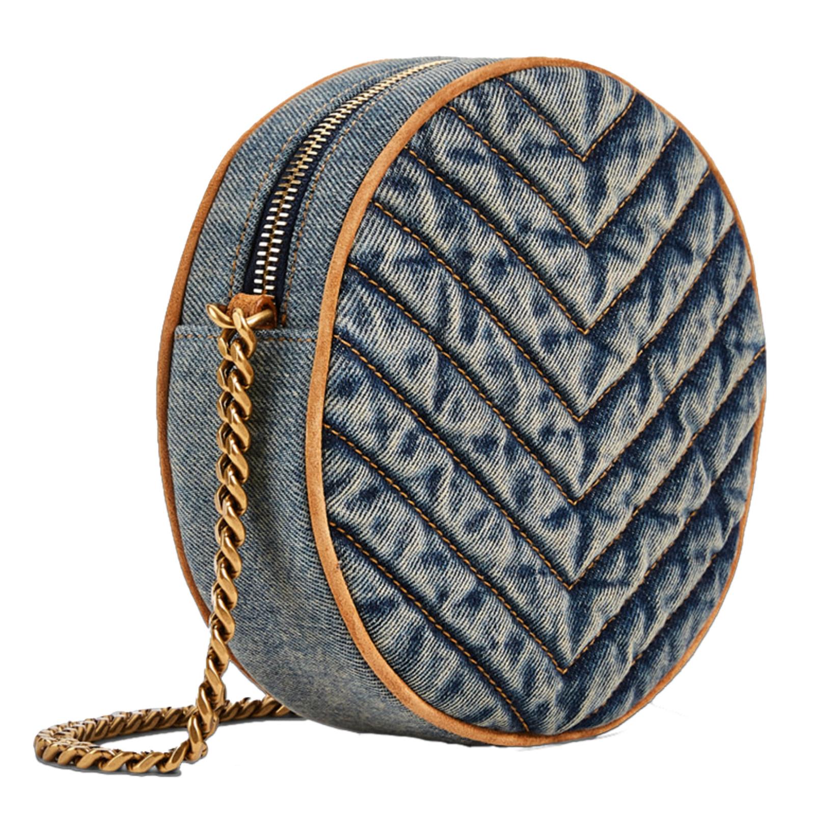 This round shoulder bag is made in Italy from quilted denim with leather and suede finishes. Featuring antiqued gold tone hardware, faded finish, chain shoulder strap with round leather reinforcement, a YSL logo plaque and chevron matelassé