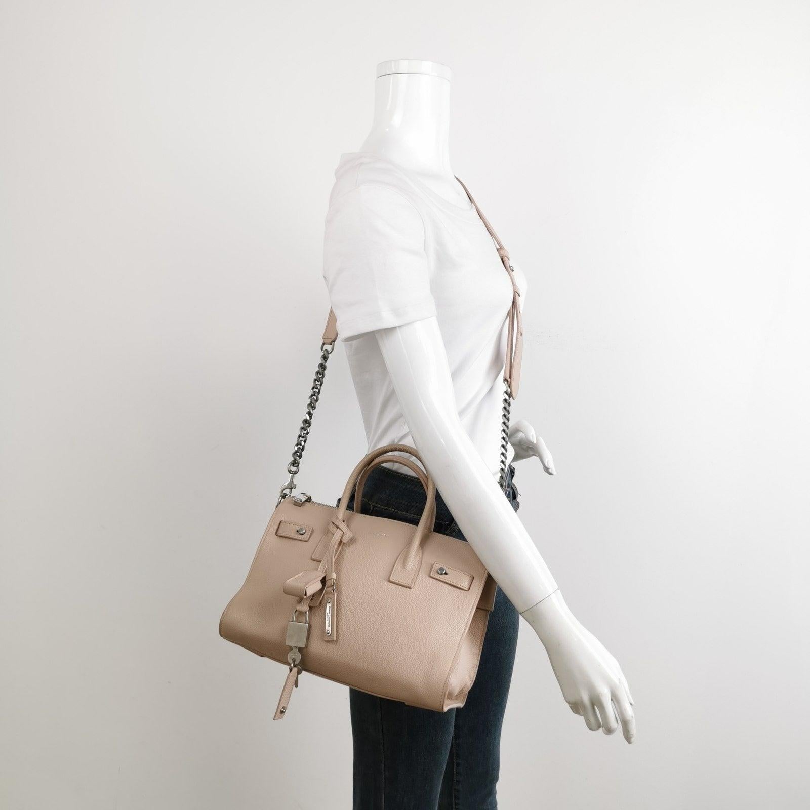 Saint Laurent Sac De Jour Baby Beige Leather Handbag These are professional photos of the actual bag offered by Luxbags. Aptly translated as the ‚Äòbag of the day‚Äô, the Sac De Jour has been a constant signature in Saint Laurent‚Äôs collections for