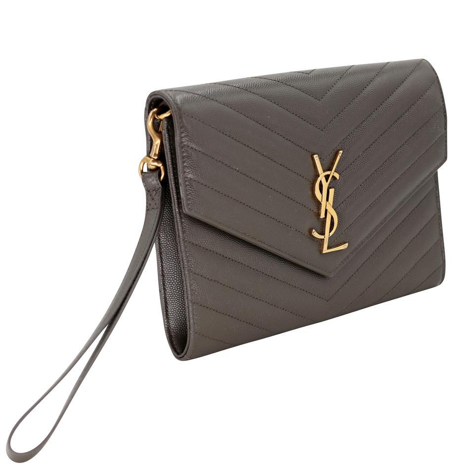 Here is a beautiful Saint Laurent with elegant olive green wristlet with bill pouch in a elegant quilted, matte powder-grain calf leather. The wallet includes signature Gold large Metal YSL monogram at center front. This is perfect for traveling or