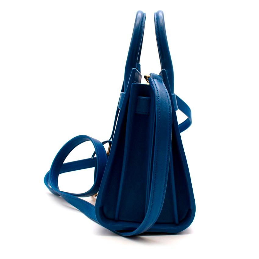 Saint Laurent Sapphire Blue Leather Sac de Jour Nano Bag

- Bronze-toned metal hardware
- Leather lining
- Open top
- Interior: one main compartment , detachable snap-button key-ring tab for padlock keys
- Five metal feet
- Detachable shouolder