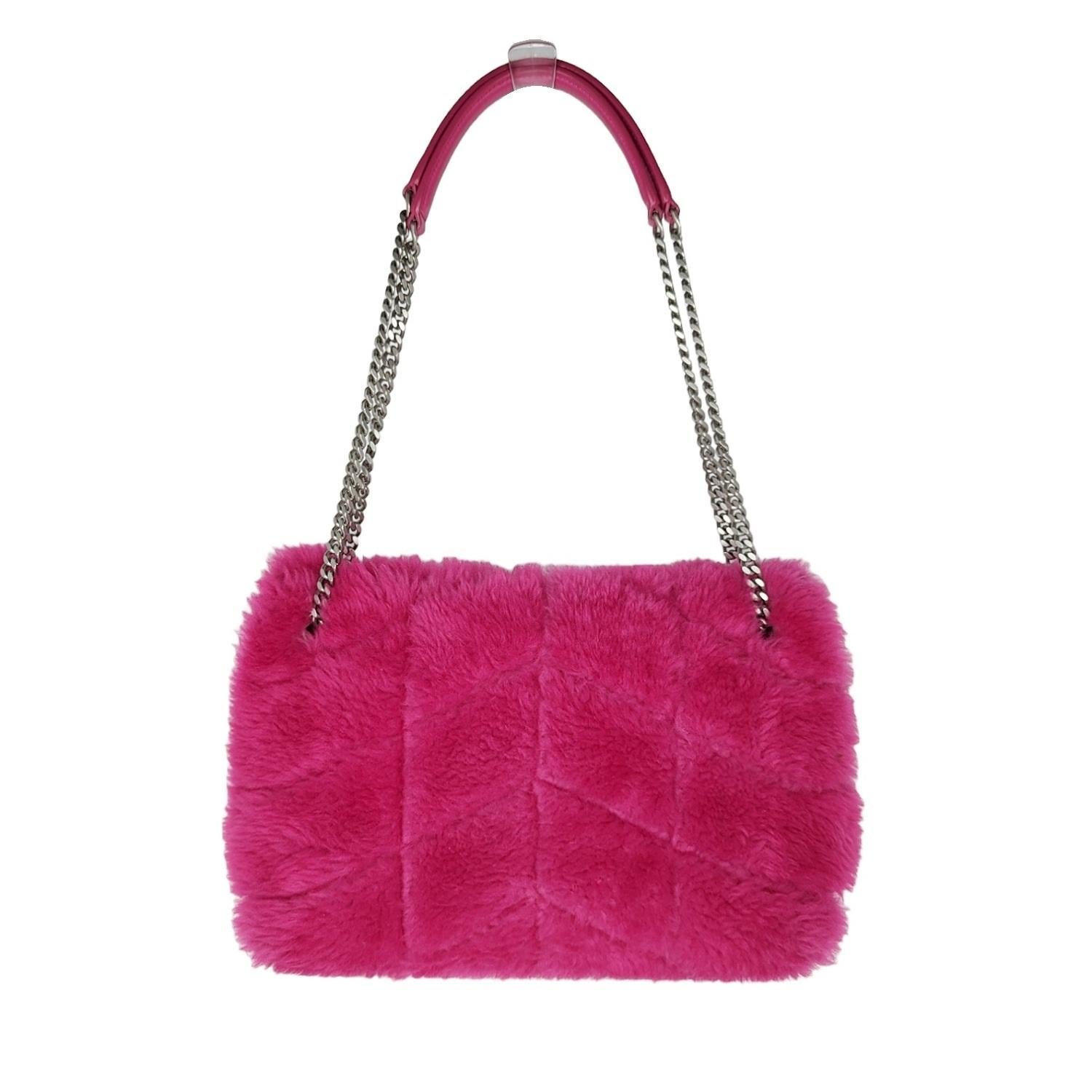 From the 2021 Collection by Anthony Vaccarello. This shoulder bag is crafted of quilted shearling in Pink. The bag has silver chain-link shoulder straps with leather shoulder pads. The front flap features a prominent YSL monogram detail and opens to