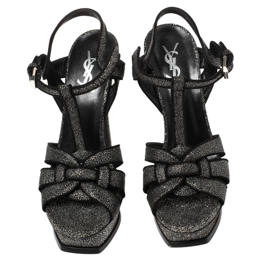 One of the most sought-after designs from Saint Laurent is their Tribute sandals. They are such a craze amongst fashionistas around the world, and it is time you own one yourself. These silver and black ones are designed with suede and glitter