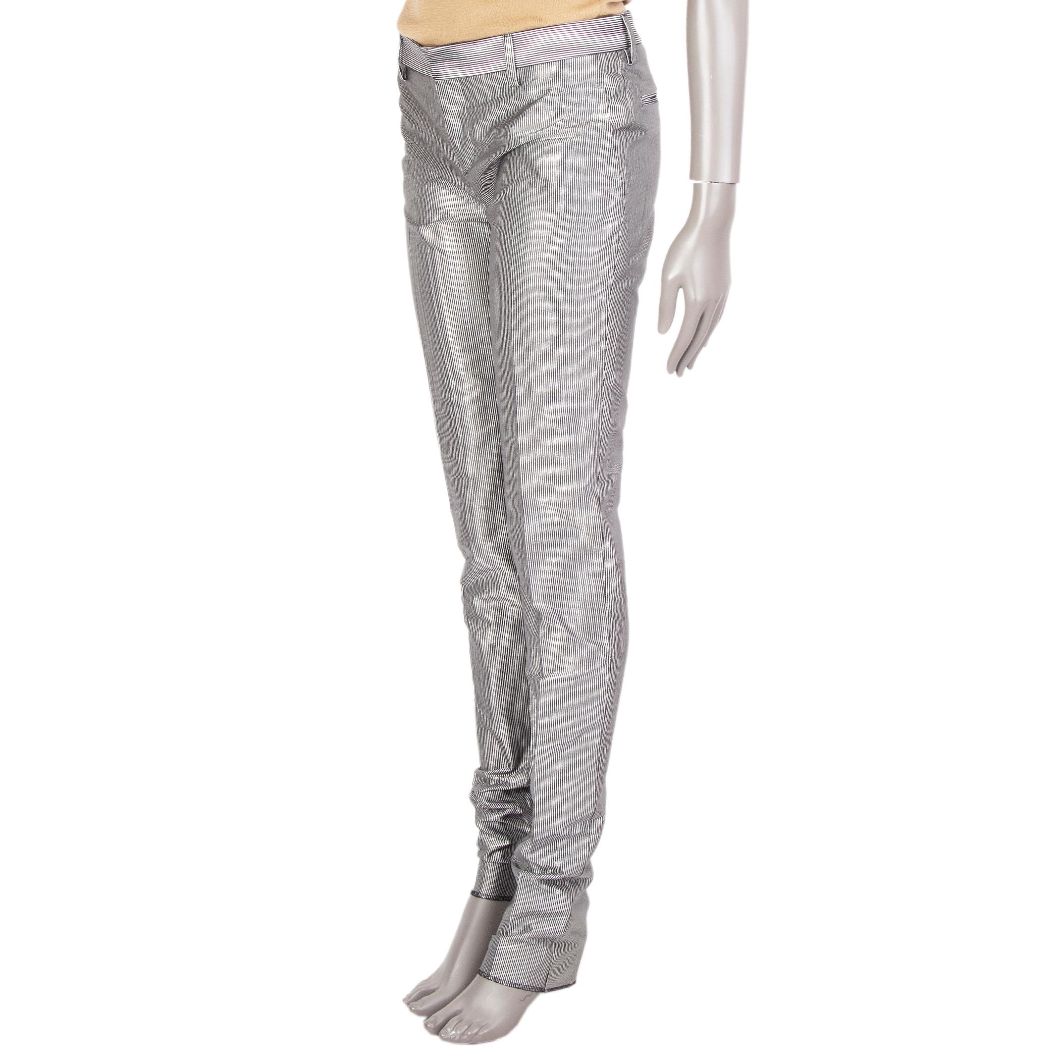 100% authentic Saint Lauren metallic-stripe pants in silver-black, polyester (73%), silk (27%). With a tapered leg, two slant pockets in the front, belt loops and two slash pockets in the back. Closes with a hidden hook and bar fastening. Unlined.