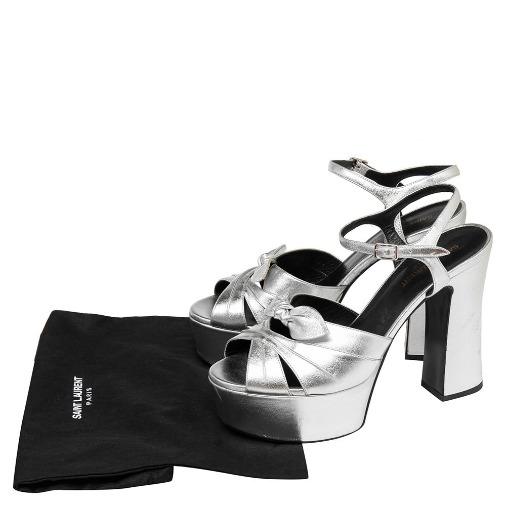 These sandals from Saint Laurent will lend a stylish and playful edge to your feet. Crafted in Italy, they are made from leather and have a lovely silhouette. They have open toes, Candy bows on the uppers, platforms, buckled ankle straps, block
