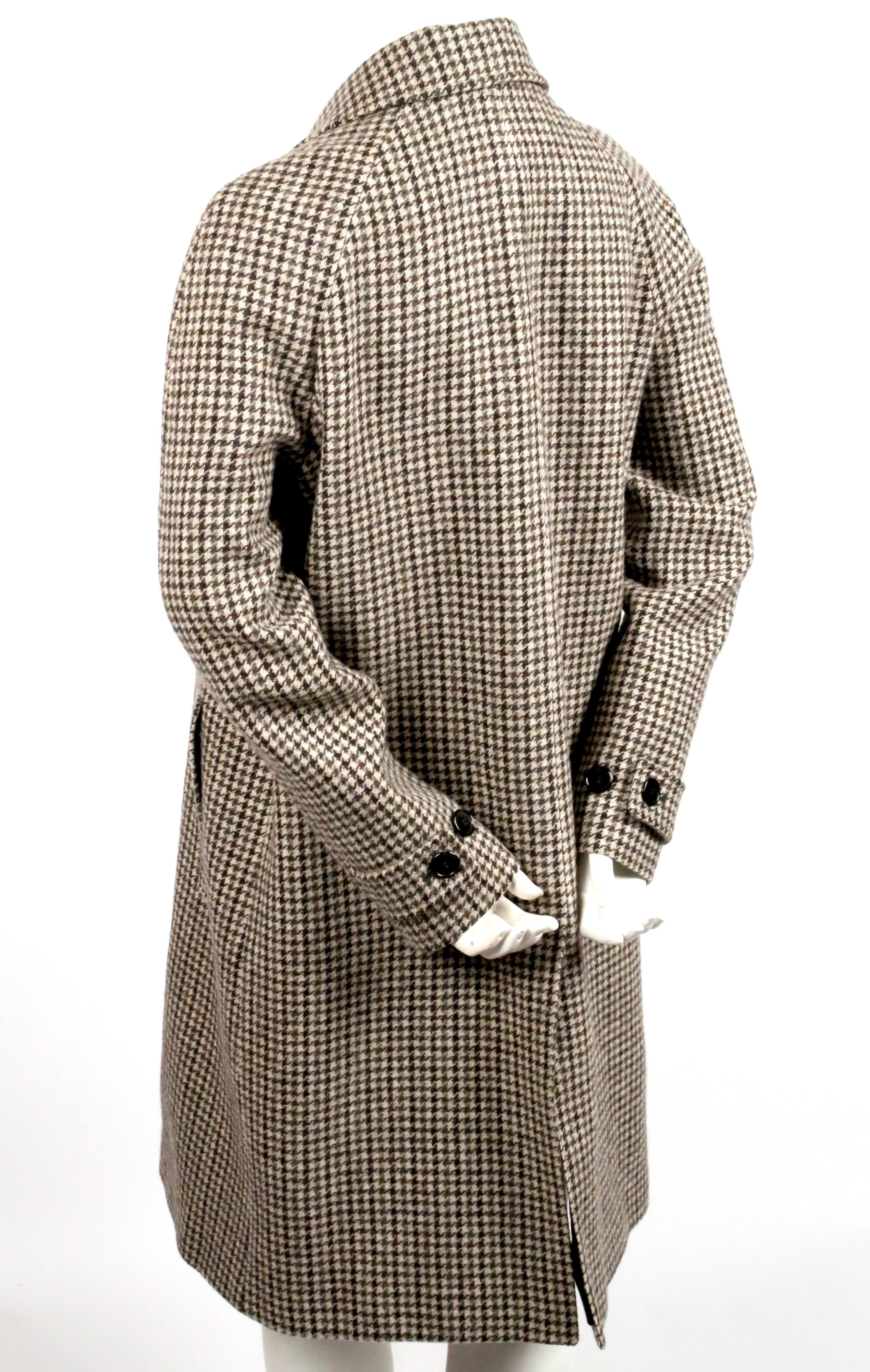 Taupe and grey houndstooth woven wool overcoat by Saint Laurent dating to fall of 2014. Same coat seen on the runway in a different fabric. French size 40. Approximate measurements: 40