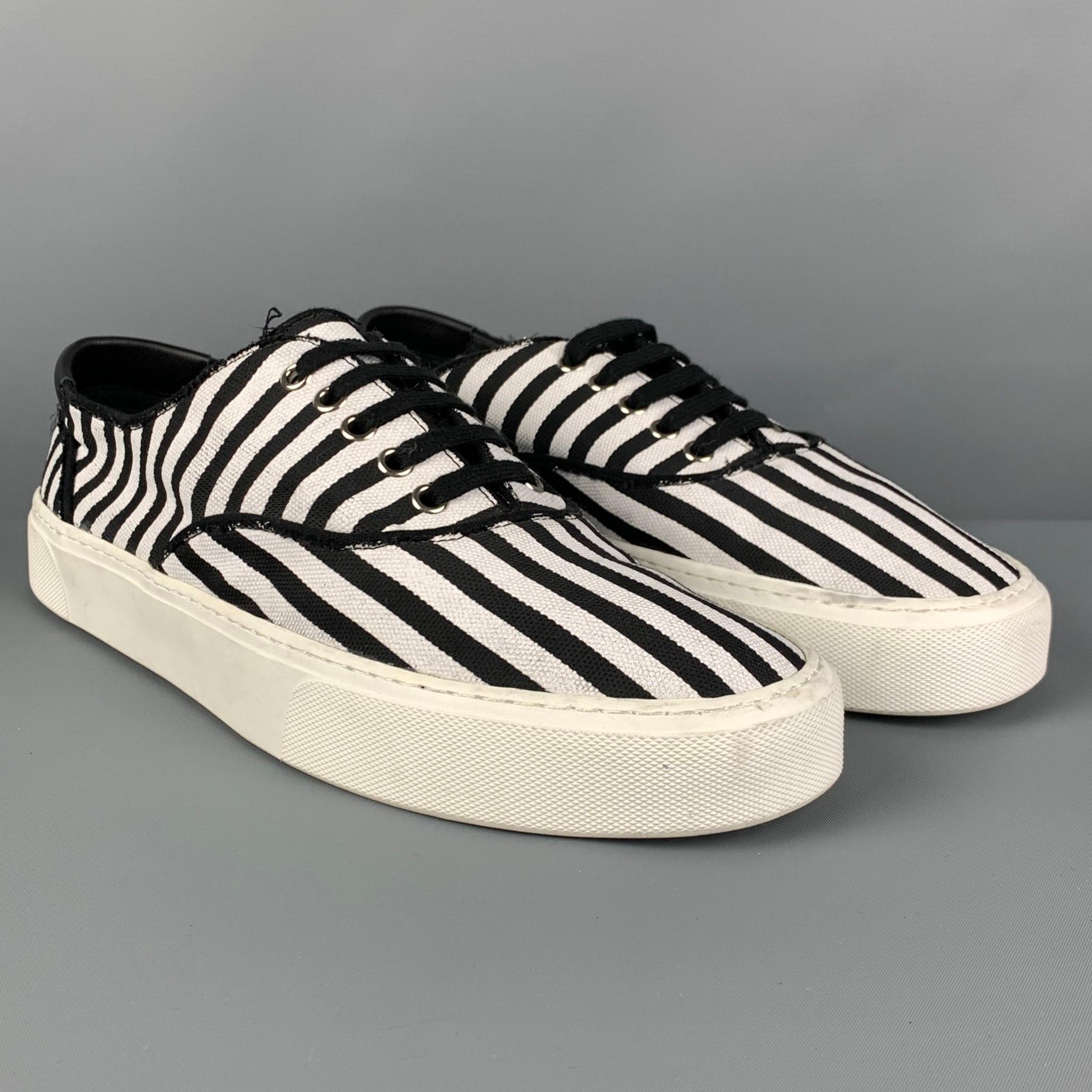 SAINT LAURENT sneakers comes in a black & white stripe canvas featuring a rubber sole and a lace up closure. 

Very Good Pre-Owned Condition.
Marked: 43

Outsole: 11.5 in. x 4 in. 