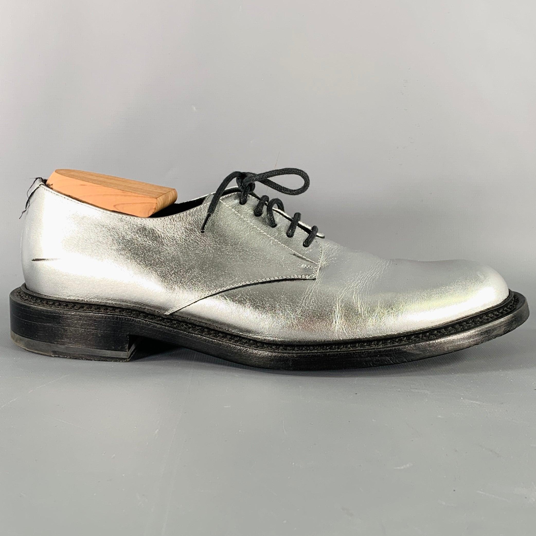 SAINT LAURENT shoes
in a metallic silver tone leather featuring a derby style, and lace-up closure. Comes with dust bag. Shoe trees not included. Made in Italy.Very Good Pre-Owned Condition. Moderate scuffs, as is. 

Marked:   BE 315307Outsole:11.75