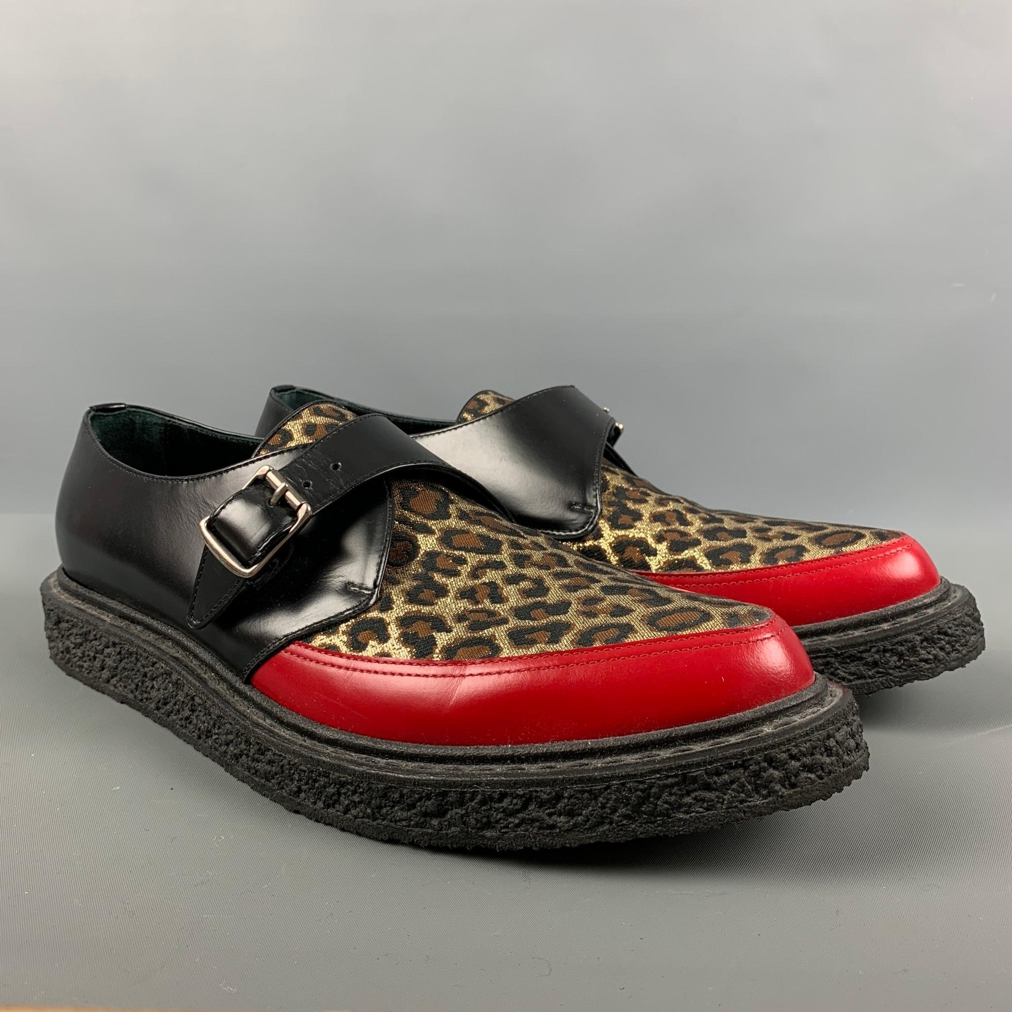 SAINT LAURENT Fall-Winter 2014 loafers comes in a black and red leather featuring a mixed material style, animal print detail, and a single monk strap. Made in Italy.

Excellent Pre-Owned Condition.
Marked: RO 362269 45

Outsole: 13 in. x 5 in 