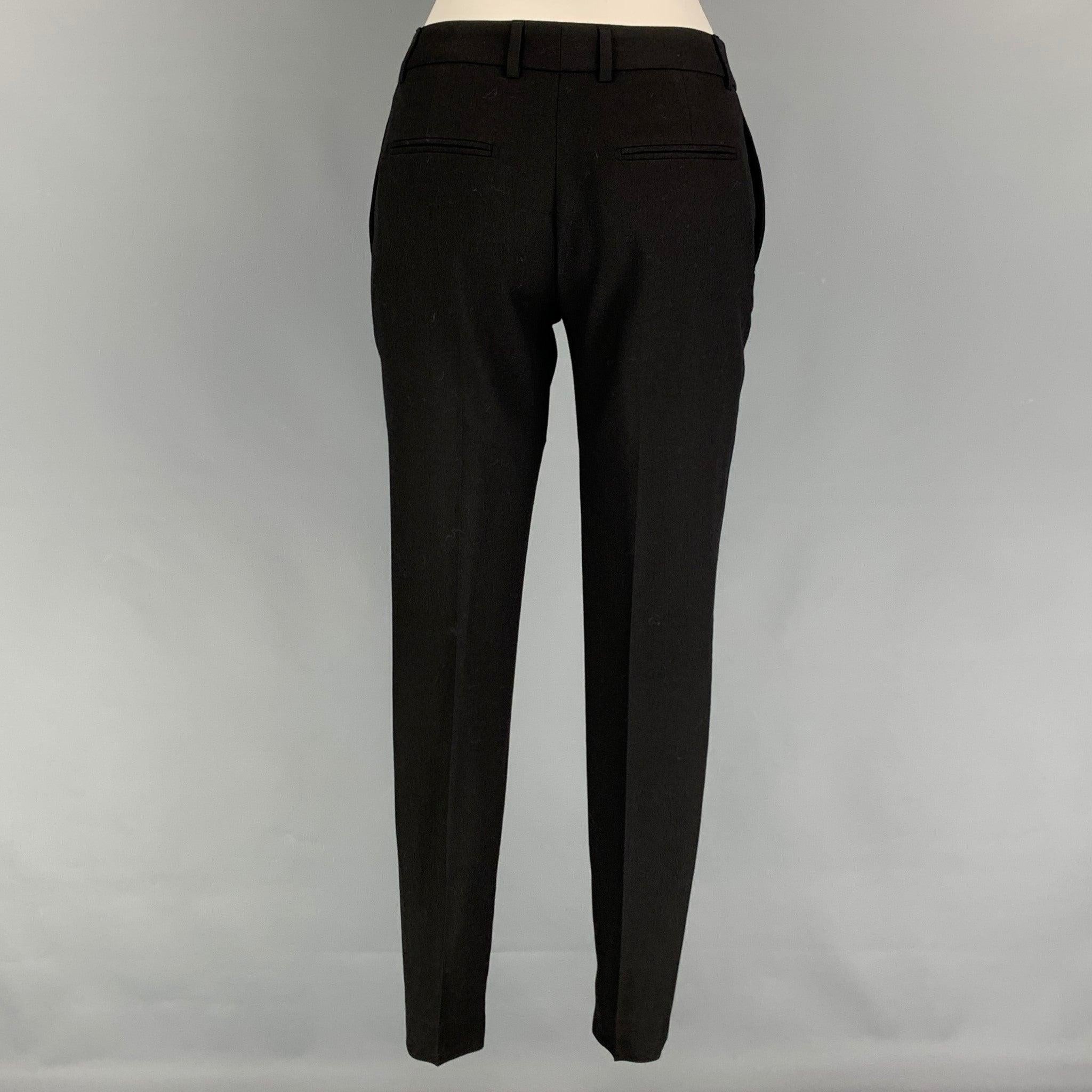 SAINT LAURENT dress pants comes in a black virgin wool featuring a skinny fit, flat front, zipped legs, front tab, and a zip fly closure. Made in Italy.
Very Good
Pre-Owned Condition. 

Marked:   F 34 

Measurements: 
  Waist: 28 inches  Rise: 8.5