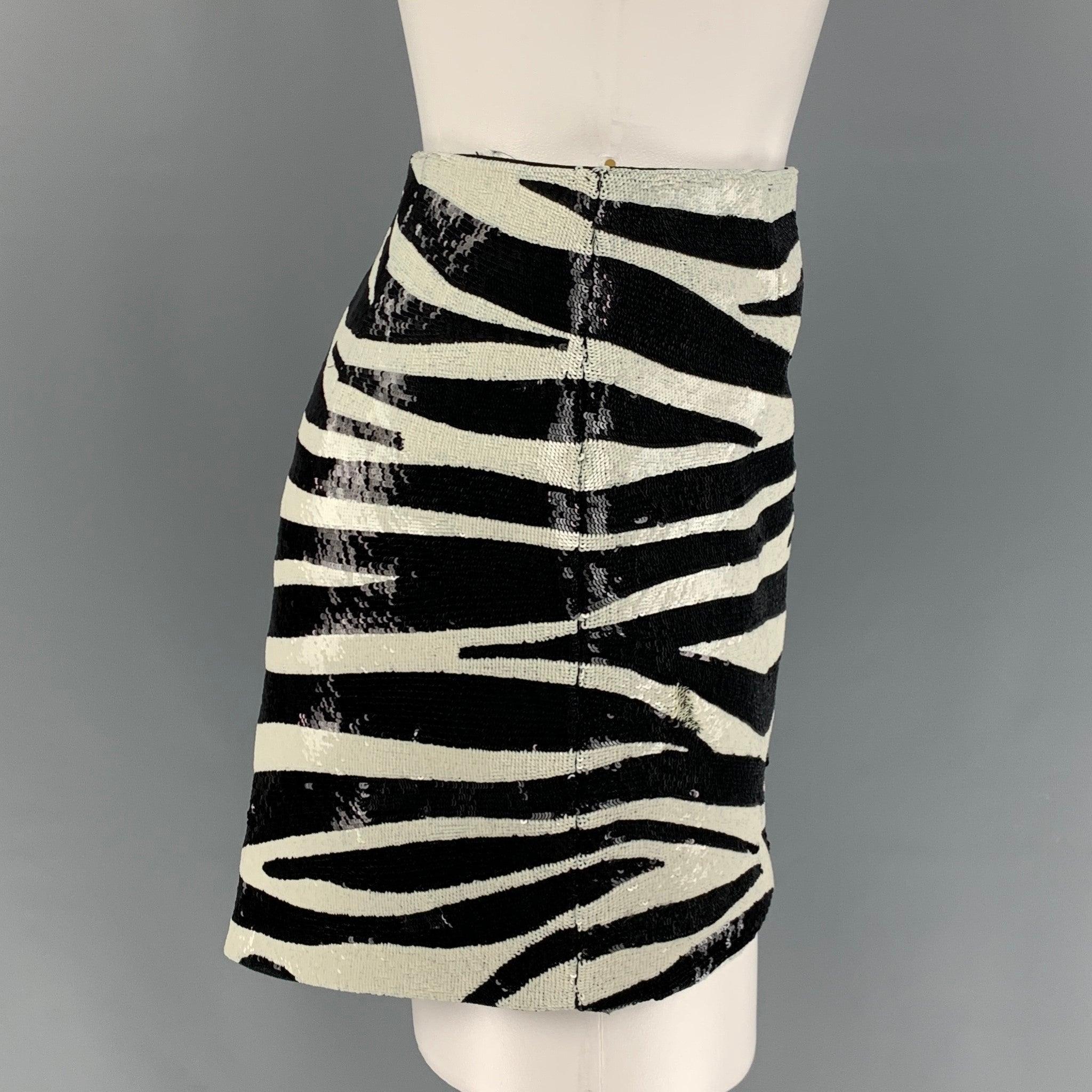 SAINT LAURENT mini skirt comes in a black & white zebra print acetate / viscose featuring an asymmetrical hem and a hidden zip up closure. Made in Italy.
Excellent
Pre-Owned Condition. 

Marked:   F 38 

Measurements: 
  Waist: 26 inches  Hip: 17