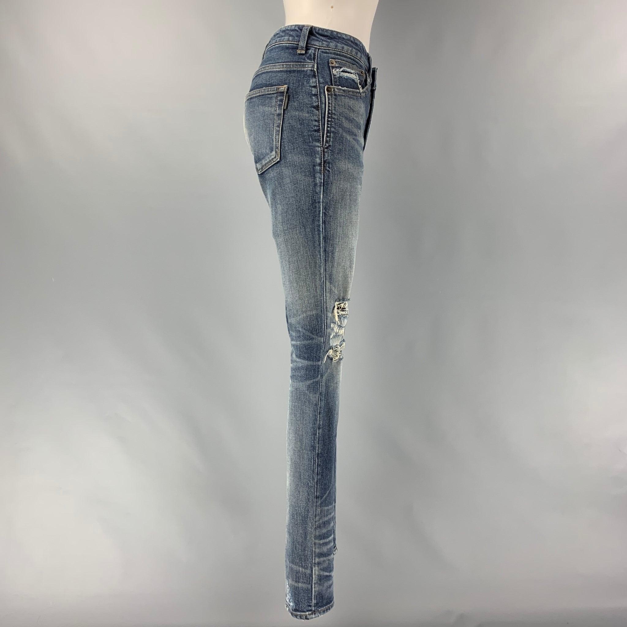 SAINT LAURENT skinny casual jeans comes in a light blue cotton and elastane washed denim featuring distressed style, five pockets, zip fly closure. Made in Japan.Very Good Pre-Owned Condition. Minor Signs of Wear. 

Marked:   26 

Measurements: 
 