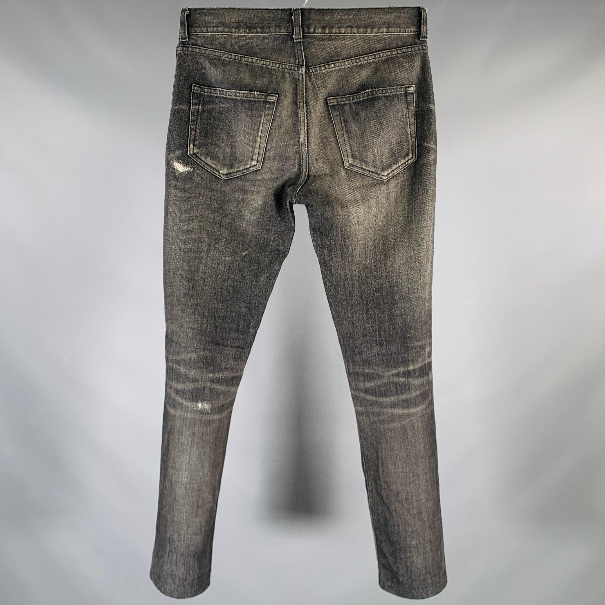 SAINT LAURENT jeans
in a charcoal grey cotton fabric featuring a distressed style, straight leg, and zip fly closure. Made in Japan.Very Good Pre-Owned Condition. Minor mark. 

Marked:   D02 M/SK-LW 

Measurements: 
  Waist: 28 inches Rise: 8 inches