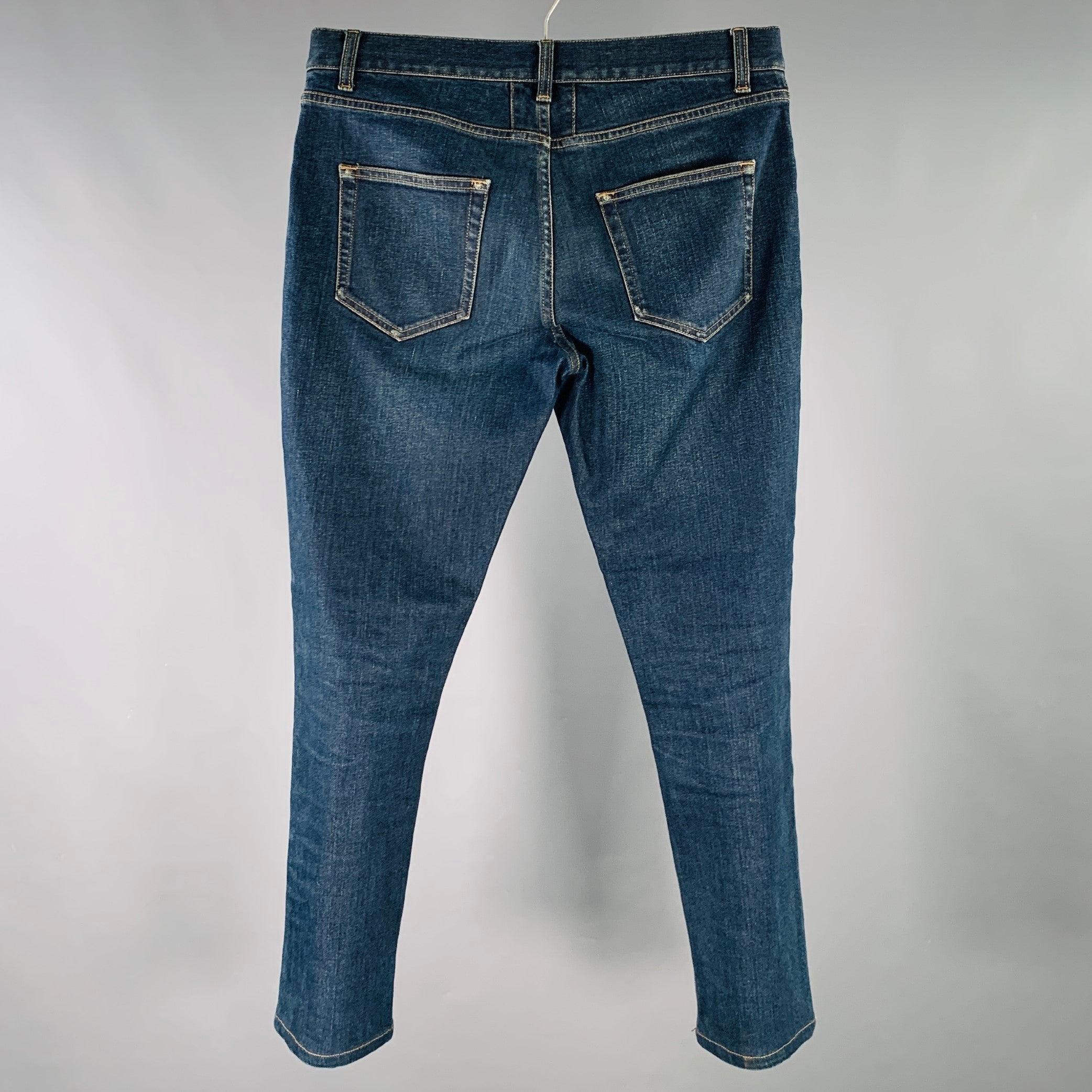 SAINT LAURENT jeans
in a blue cotton stretch blend denim featuring yellow contrast stitching, straight leg, and zip fly closure. Made in Italy.Excellent Pre-Owned Condition. 

Marked:   30 

Measurements: 
  Waist: 30 inches Rise: 8.5 inches Inseam:
