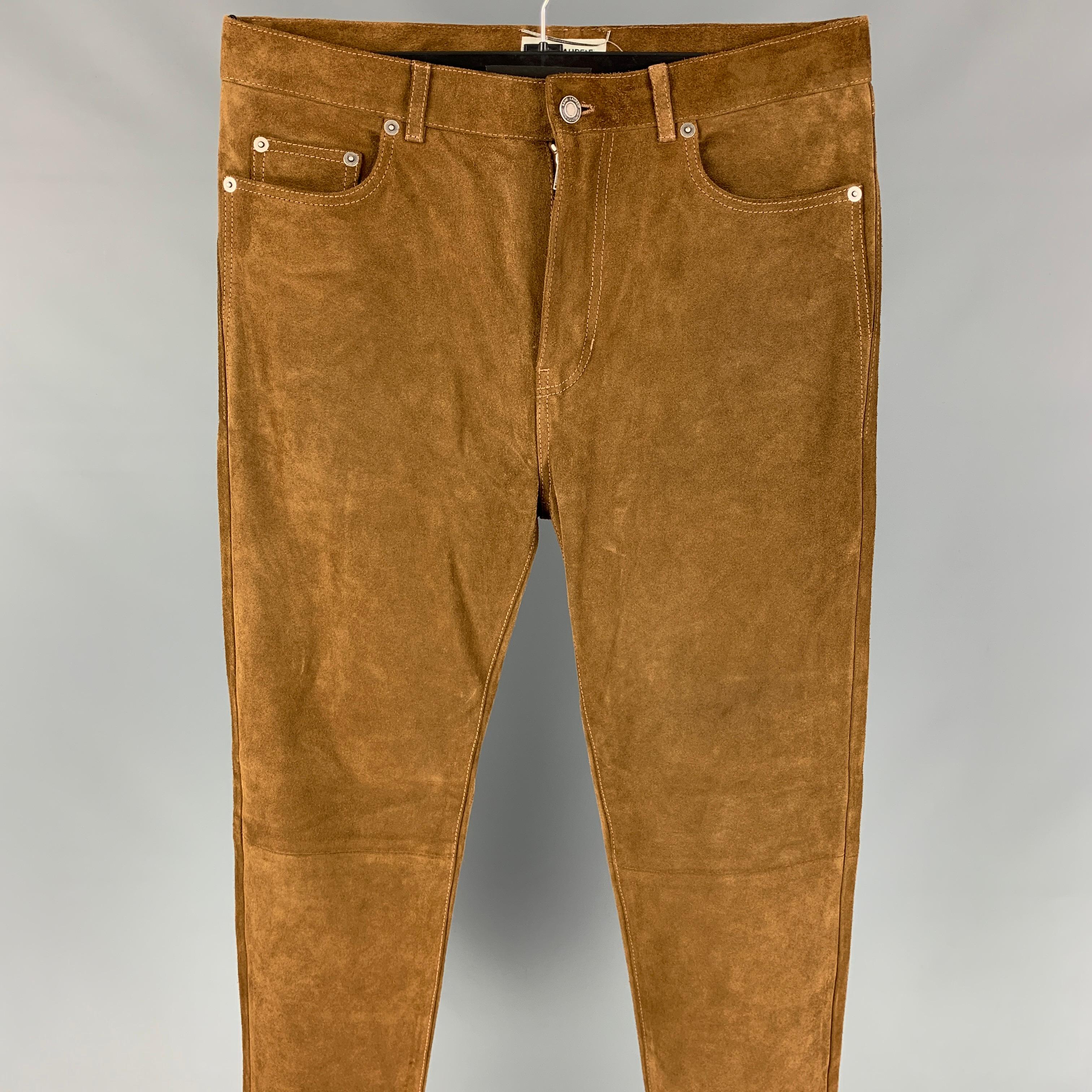 SAINT LAURENT casual pants comes in a brown & tan suede with silk lining featuring a slim fit, contrast stitching, and a zip fly closure. Made in Italy. 

Excellent Pre-Owned Condition.
Marked: 46
Original Retail Price:
