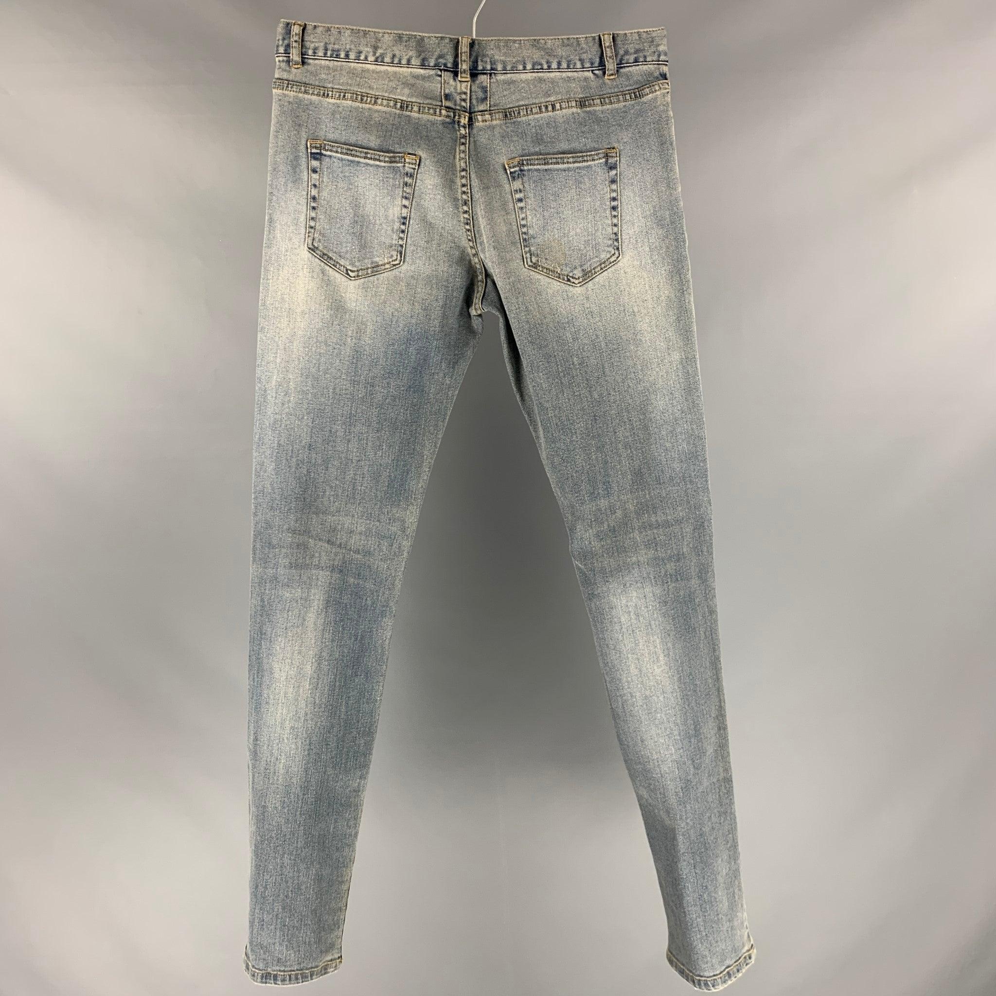 SAINT LAURENT x DO2 jeans comes in a blue denim woven material featuring a regular fit, five pockets, distressed detailing and zipper fly closure.Good Pre-Owned Condition. As-is. Please check photos. 

Marked:   size not marked 

Measurements: 
 
