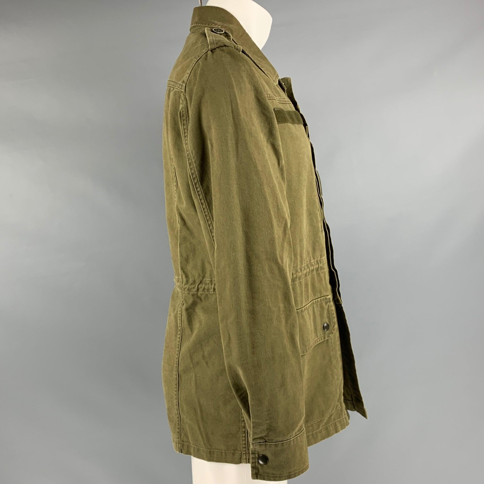 SAINT LAURENT SS2019 by Anthony Vaccarelo
jacket in a khaki cotton ramie blend fabric featuring a utility style, four pockets, and hidden button closure. Made in Italy.Excellent Pre-Owned Condition. 

Marked:   48 

Measurements: 
 
Shoulder: 18.5
