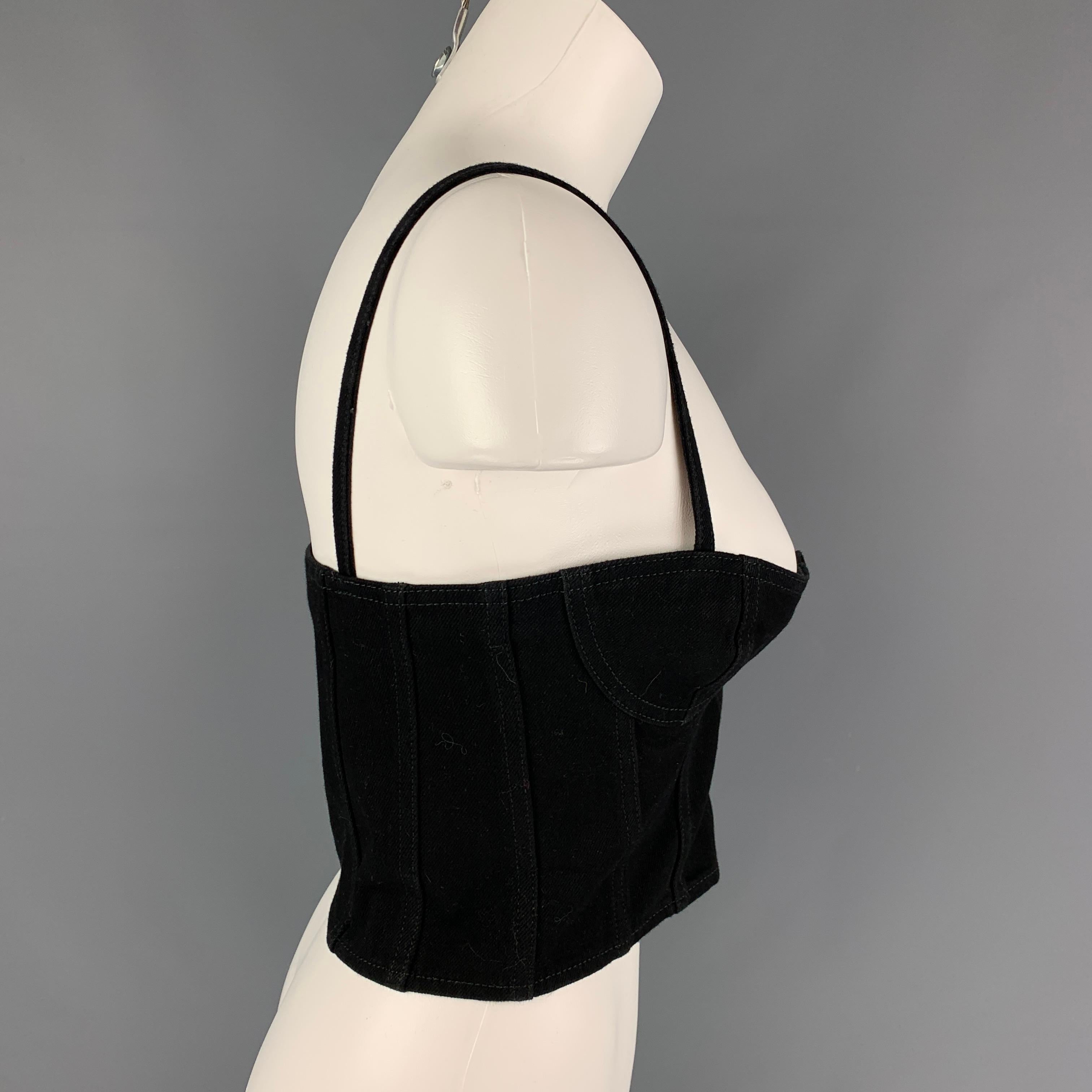 SAINT LAURENT top comes in a black denim featuring fixed spaghetti straps, top stitching, and a front buttoned closure. Made in Italy. 

Excellent Pre-Owned Condition.
Marked: F36
Original Retail Price: $790.00

Measurements:

Bust: 30 in.
Length: 8