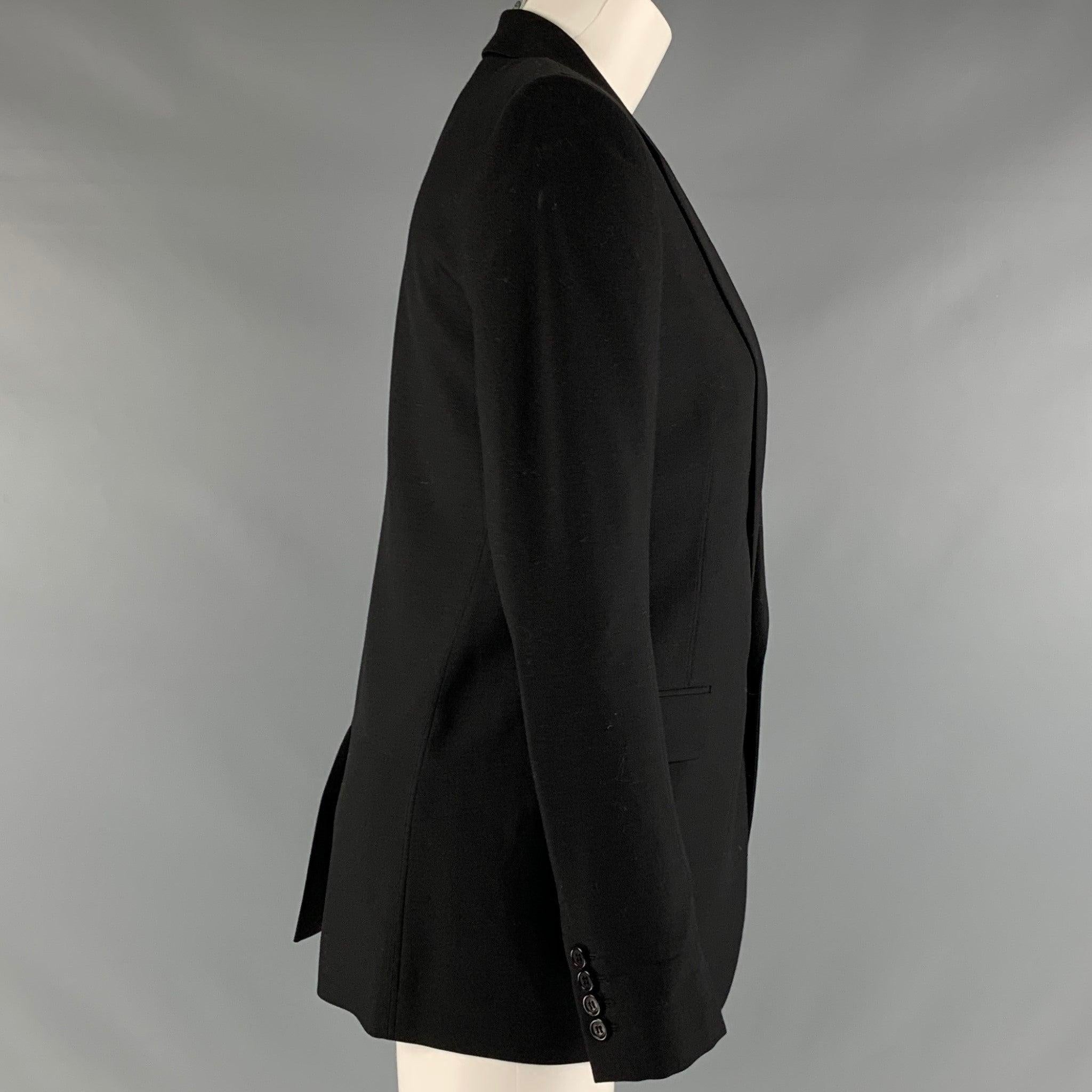 SAINT LAURENT blazer comes in a black virgin wool twill with a full liner featuring a peak collar, shoulder pads, and a single button closure. Made in Italy.Excellent Pre-Owned Condition. 

Marked:   4 

Measurements: 
 
Shoulder: 15 inches Bust: 36