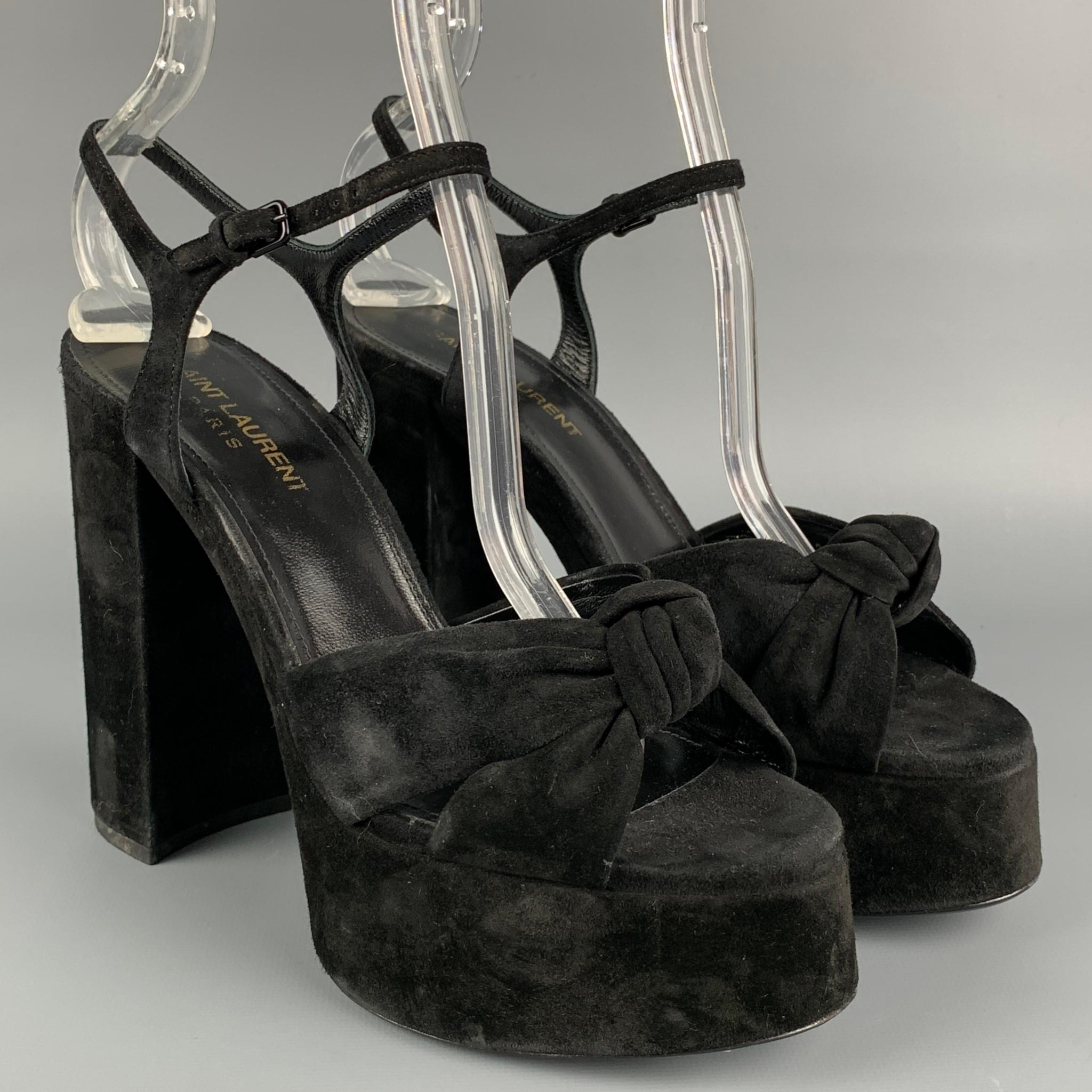 SAINT LAURENT 'Bianca' sandals comes in a black featuring a front knot detail, platform, chunky heel, and a ankle strap closure. Made in Italy. 

Good Pre-Owned Condition.
Marked: 606713 37.5
Original Retail Price: $895.00

Measurements:

Heel: 5