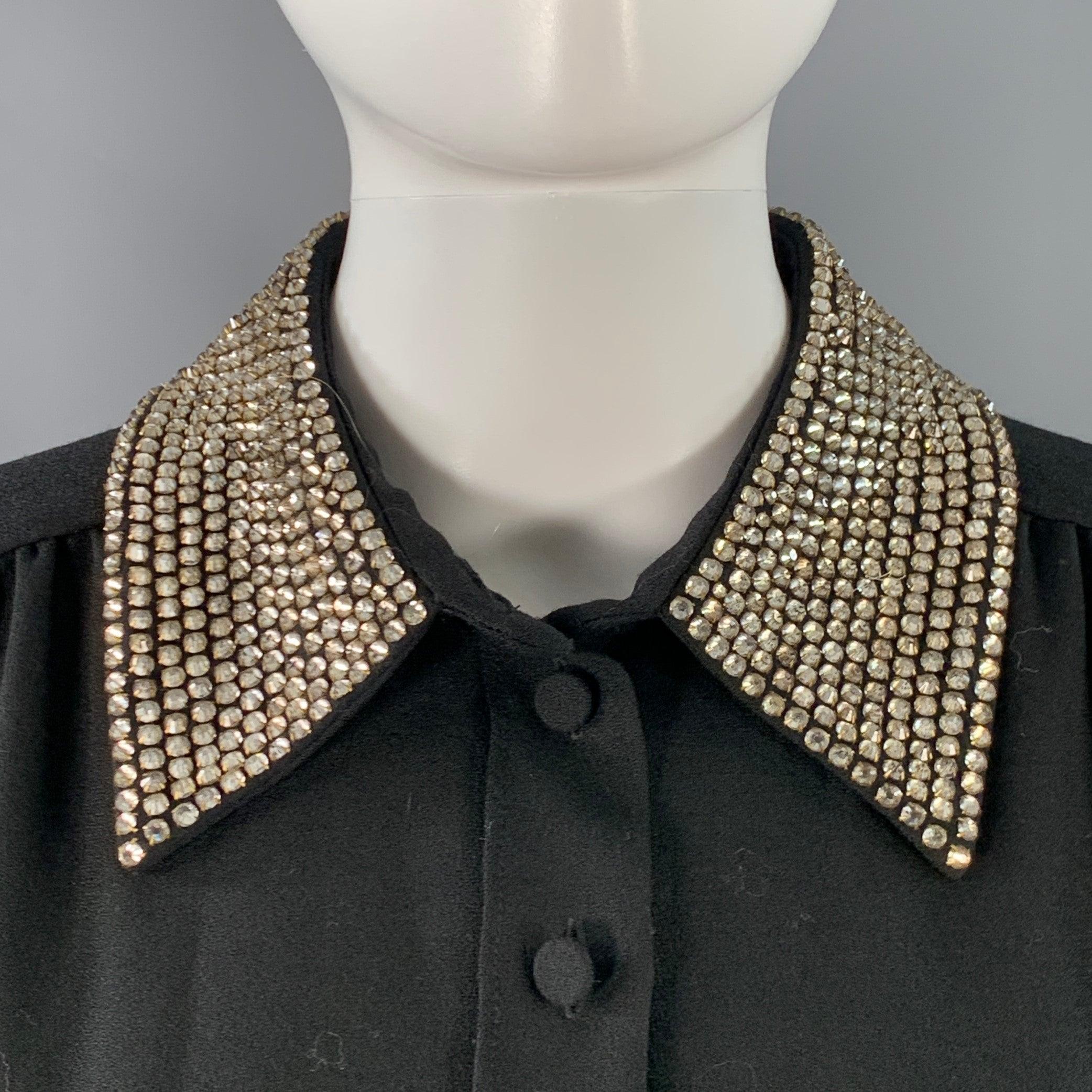 SAINT LAURENT dress
in a black wool crepe featuring a stunning rhinestone studded collar with studded cuff details, long sleeves, and front button closure with invisible side zipper. Made in France.Very Good Pre-Owned Condition. Missing very top