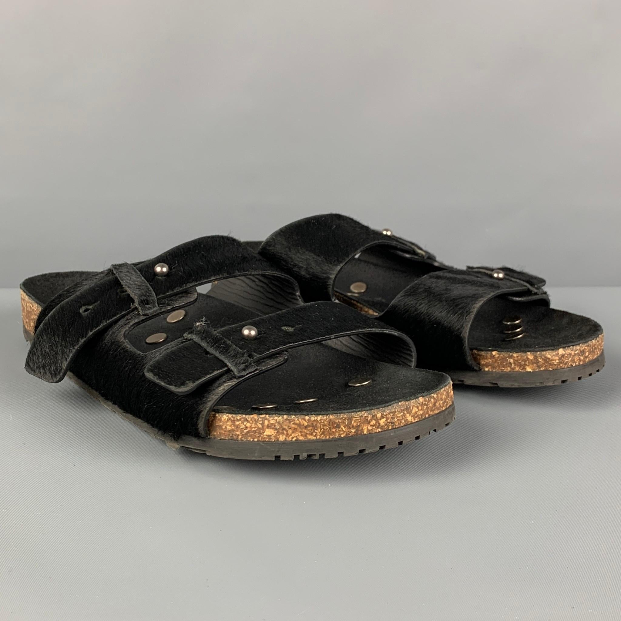 SAINT LAURENT sandals comes in a black textured pony hair leather featuring adjustable straps and a rubber sole. Made in Italy.

Very Good Pre-Owned Condition.
Marked: 42

Outsole: 11 in. x 3.75 in. 