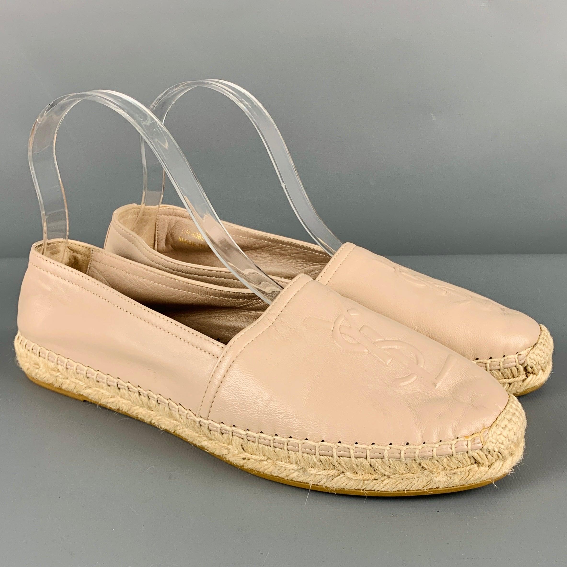 SAINT LAURENT flats
in a beige leather featuring an espadrille style, embossed monogram logo, and slip on closure. Made in Spainches Very Good Pre-Owned Condition. Minor signs of wear. 

Marked:   CR 458573 39.5Outsole: 10.5 inches  x 3.25 inches 
 