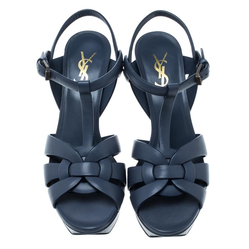 This amazing pair of slate blue sandals is from Saint Laurent Paris. They have been crafted from leather and styled with intertwining straps at the toe. The Tribute sandals come with adjustable ankle fastenings, comfortable insoles, and 10.5 cm