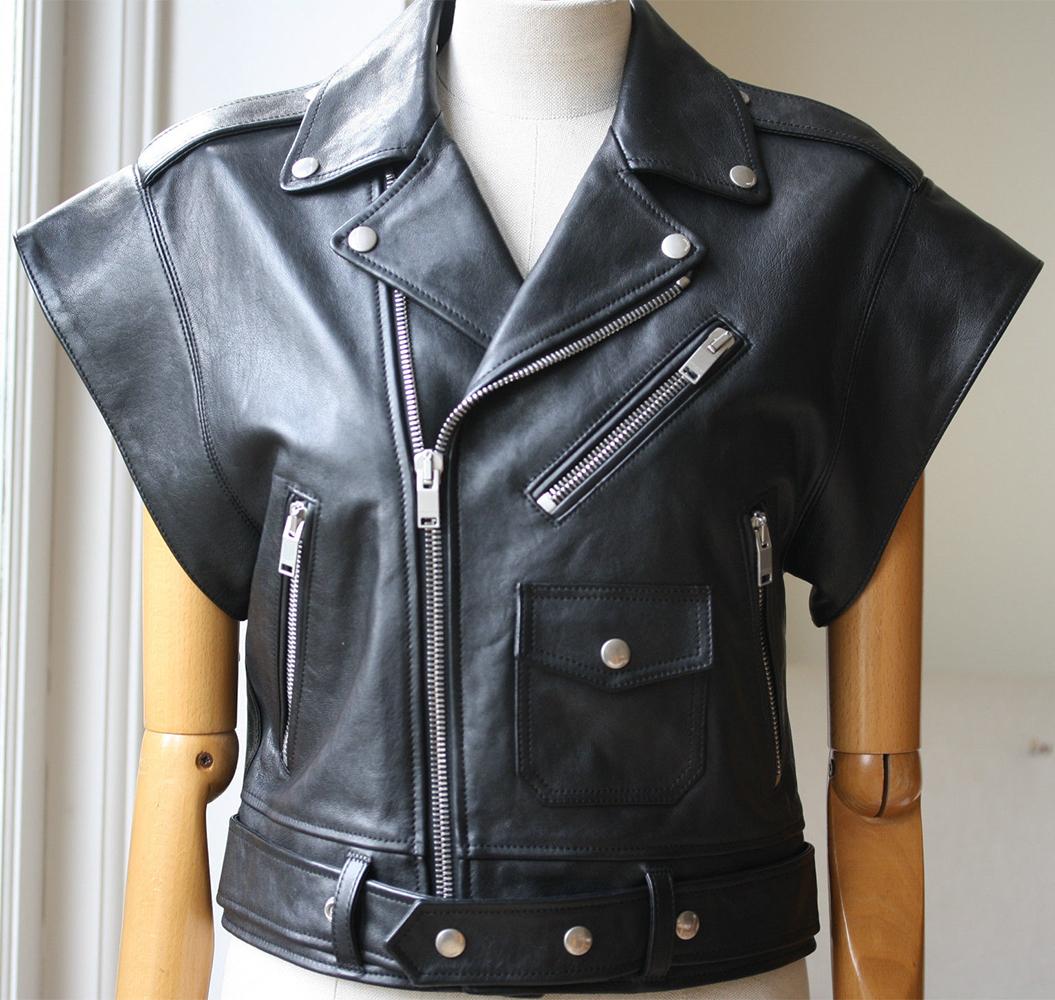 Saint Laurent's sleeveless leather biker jacket is perfect for layering - the loose, boxy fit makes it easy to slip over everything from sleek dresses to chunky knitwear. Black leather. Snap-fastening epaulettes, collar, lapels and waist tabs, three