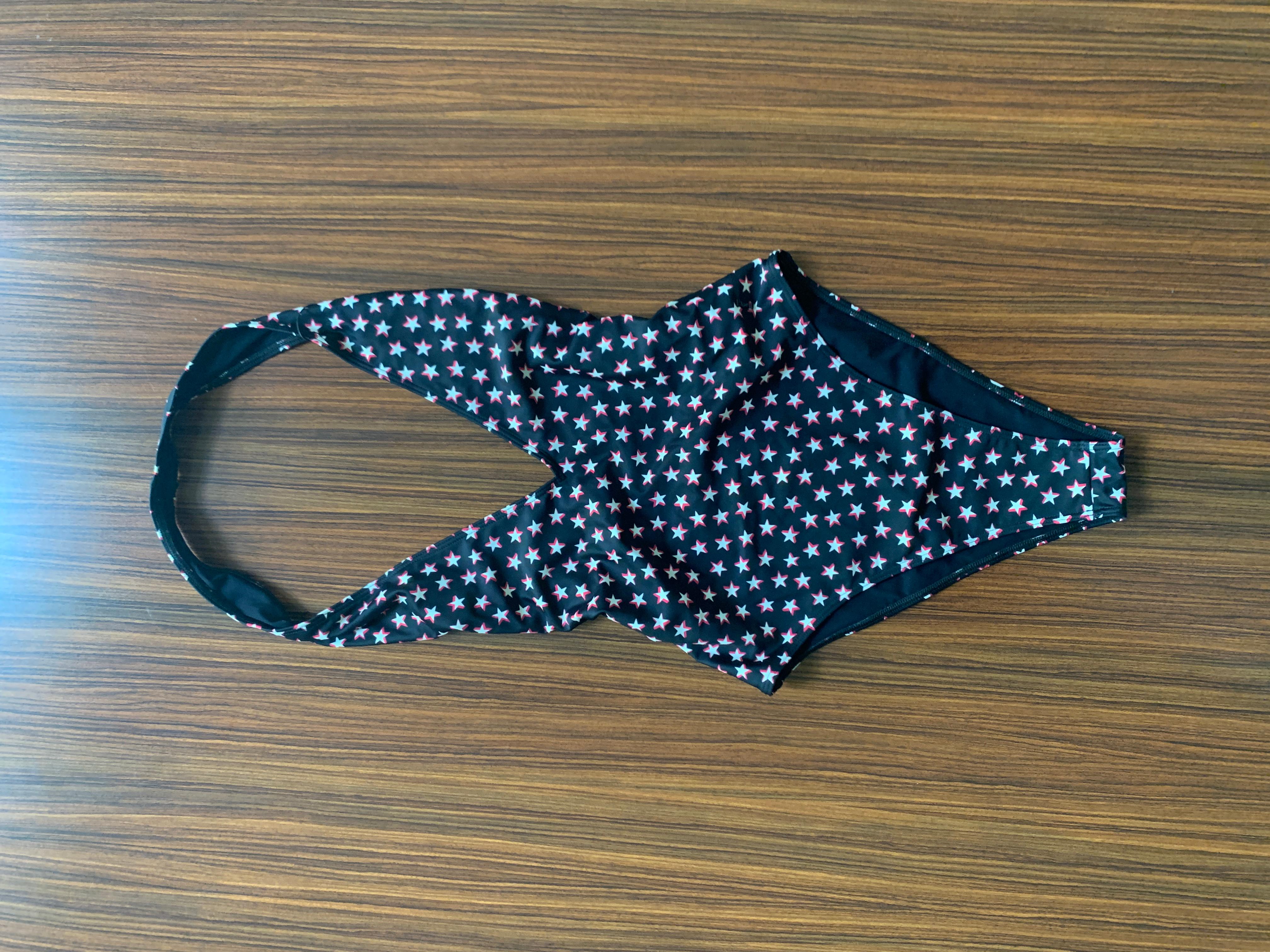 Yves Saint Laurent black one piece halter swimming suit with red and white star print throughout. Flattering high cut legs and low cut back. Small metal YSL logo at hip. 

82% polyamide, 18% spandex.

Made in Italy. 

Size XS.

Excellent condition,