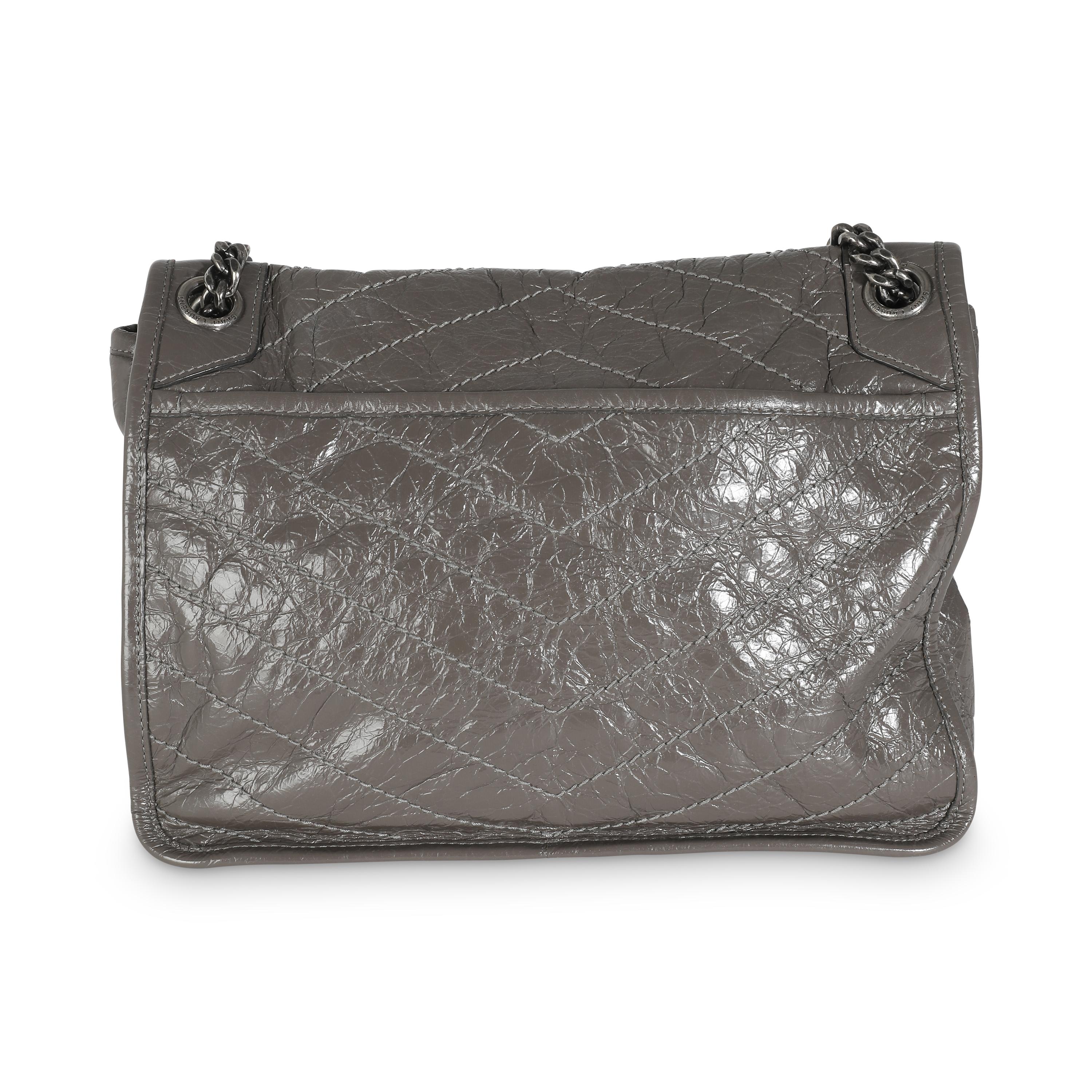 Listing Title: Saint Laurent Storm Crinkled Calfskin Matelasse Medium Niki Chain Satchel
SKU: 141358
Condition: Pre-owned 
Handbag Condition: Very Good
Condition Comments: Item is in very good condition with minor signs of wear.  Scuffing along
