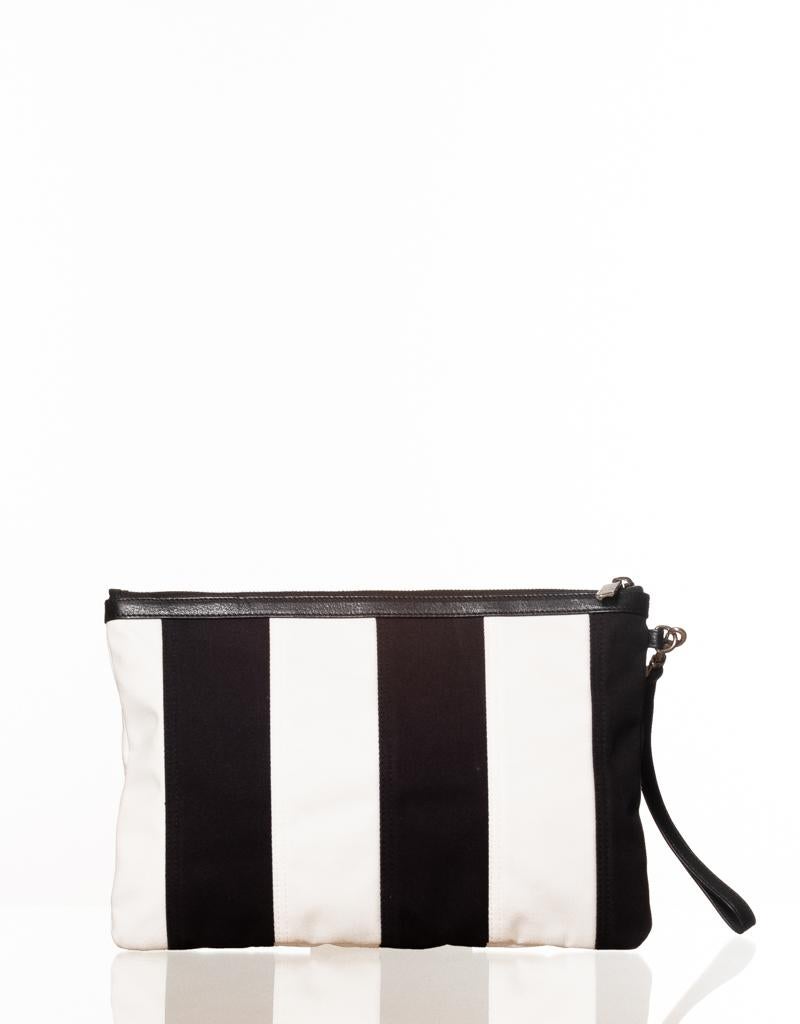 Saint Laurent padded cotton canvas pouch features patchwork stripes in black and white, red contrast logo embroidery on the front, leather hems, a removable wristlet, zip closure and black grosgrain lining.

COLOR: Black and white
MATERIAL: Canvas