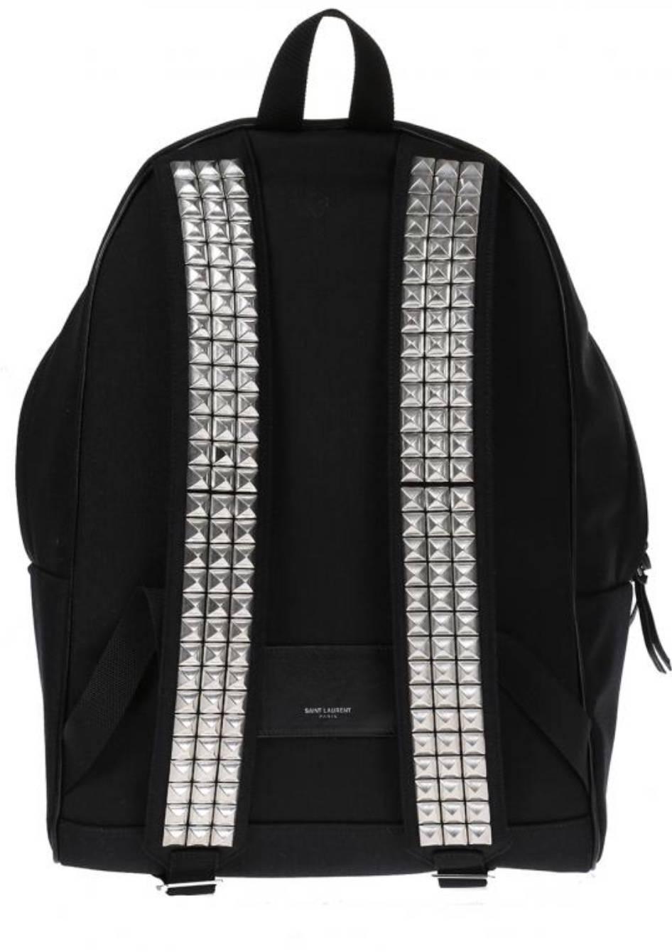Black cotton backpack from Saint Laurent. Two-way zip fastening. Leather pocket on the front with a zebra motif print. Decorative silver-tone studs. Embossed logo on the front. Main inetrnal compartment with a zip pocket. Adjustable shoulder straps