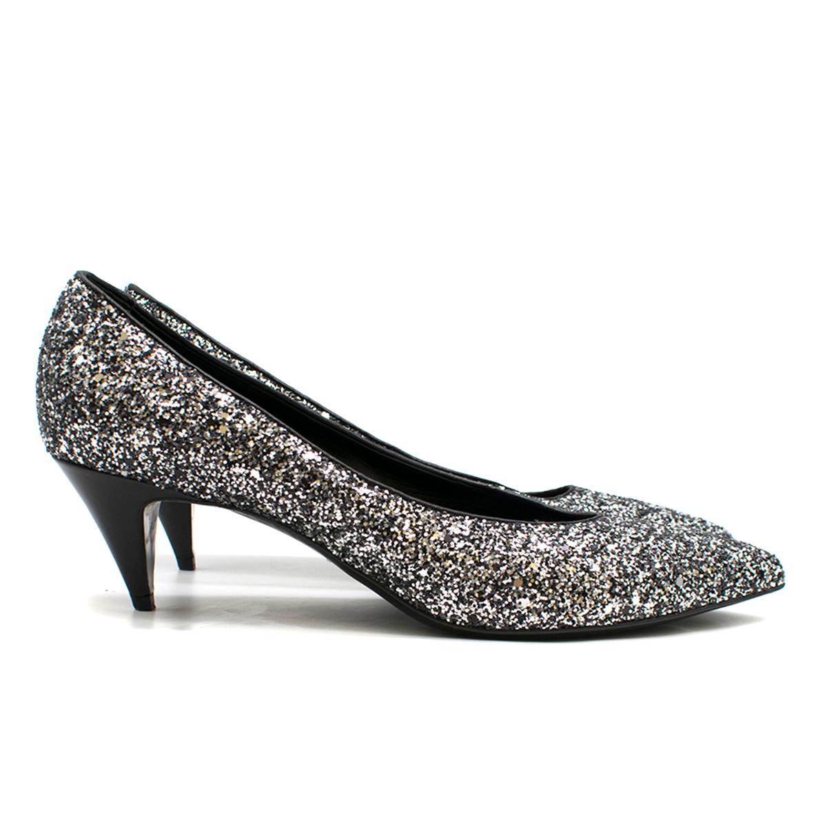 Saint Laurent Tara 55 Black Glitter Kitten Heel Pumps

- Silver & Black Pumps 
- Glitter covered leather outer 
- Point toe, slim toeline 
- Black leather lining
- 55 mm leather covered stiletto heel 

Please note, these items are pre-owned and may