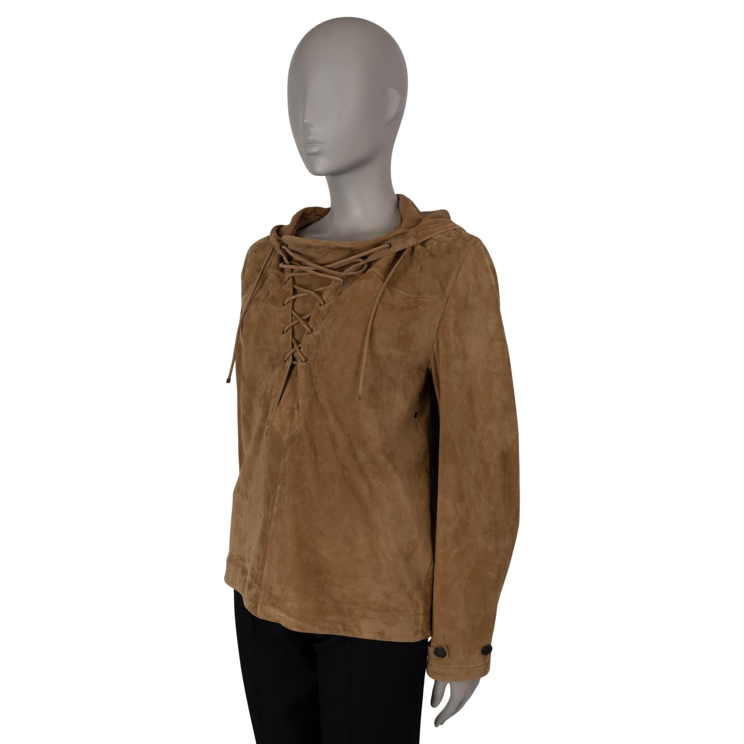 This 100% authentic Saint Laurent slip-on jacket in tobacco brown lambskin suede exudes effortless style. It features a lace-up front, a drawstring hem with tonal cotton cords, a hood, and buttoned cuffs for a laid-back yet sophisticated look.
