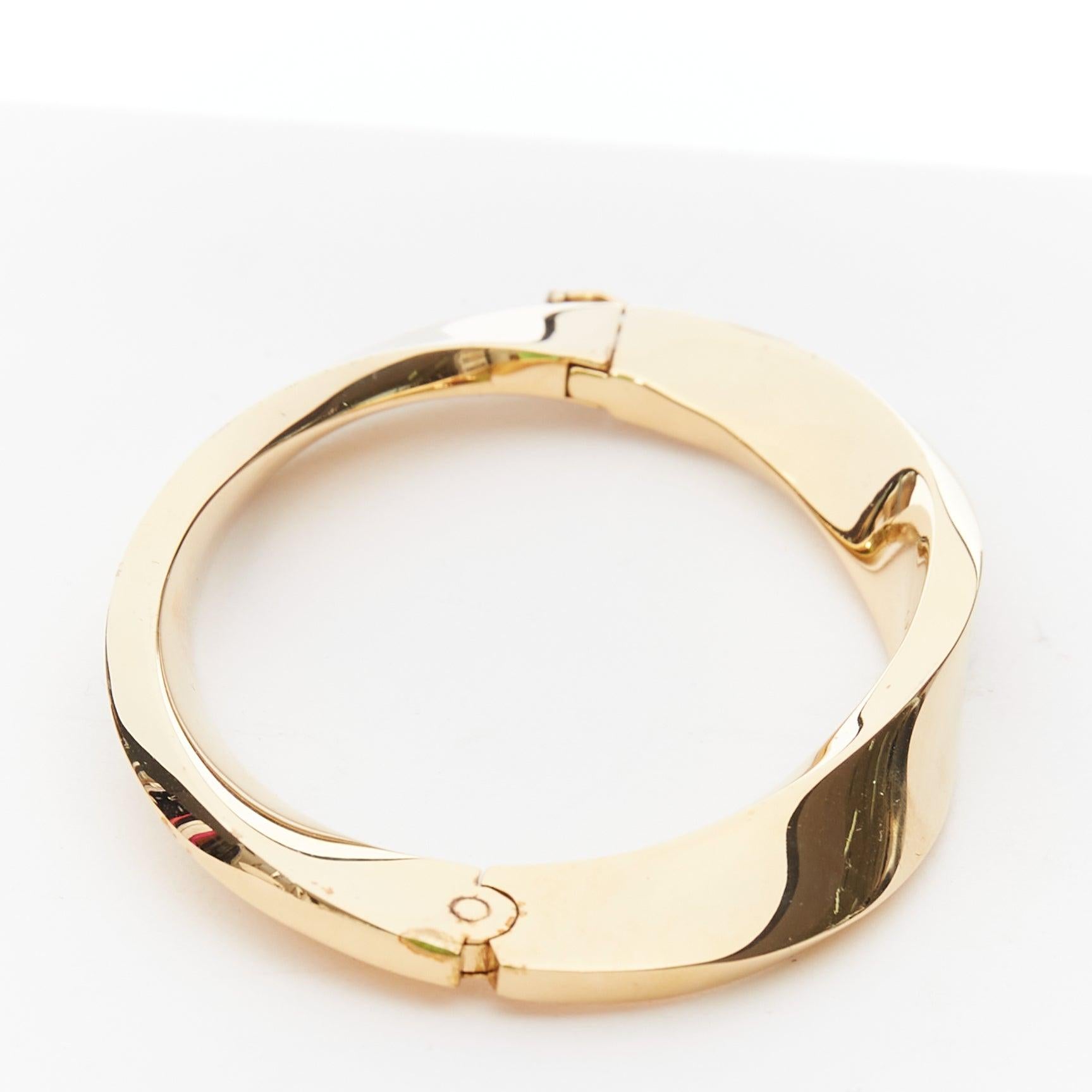 SAINT LAURENT Twisted gold double push clasps hard bangle
Reference: TGAS/E00620
Brand: Saint Laurent
Material: Metal
Color: Gold
Pattern: Solid
Closure: Push Clasp
Extra Details: gold-tone metallic effect high-shine finish twist