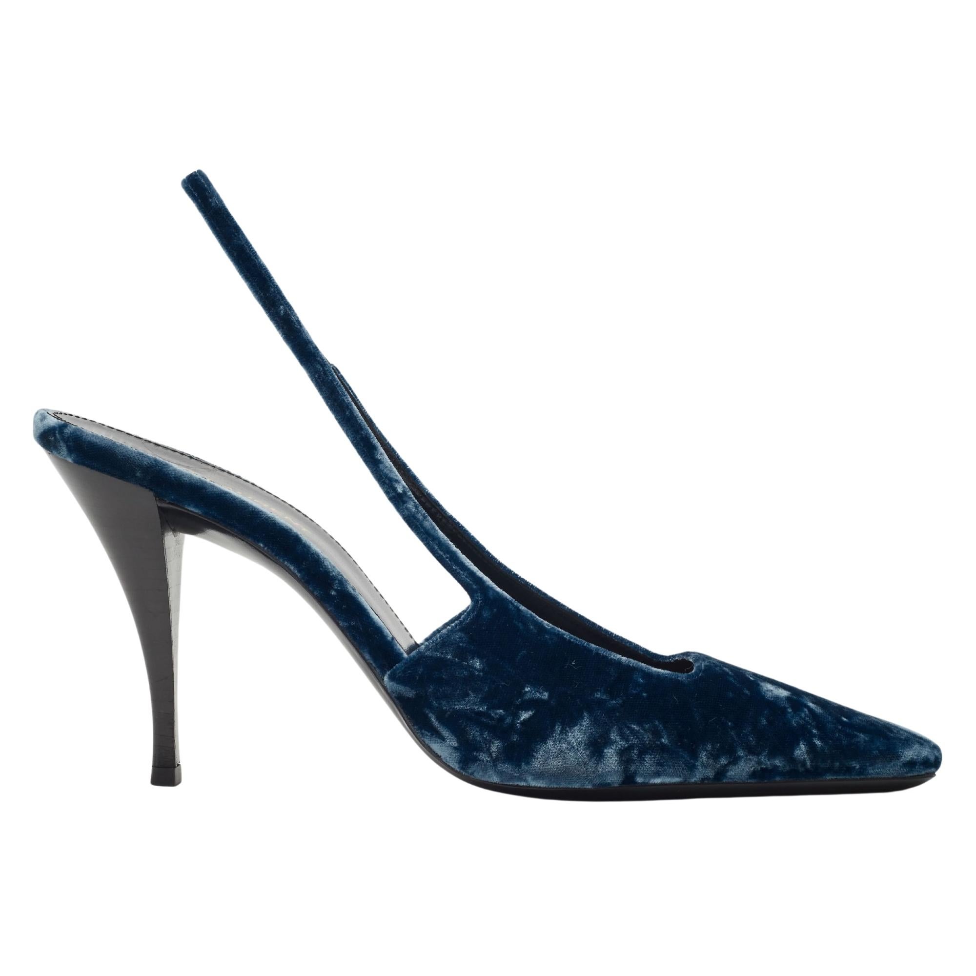 This Saint Laurent heel features a crushed velvet upper paired with a sleek leather sole. Made in Italy, the design includes a slingback style and a leather lining and footbed. The tapered toe complements the unique curved heel, which measures