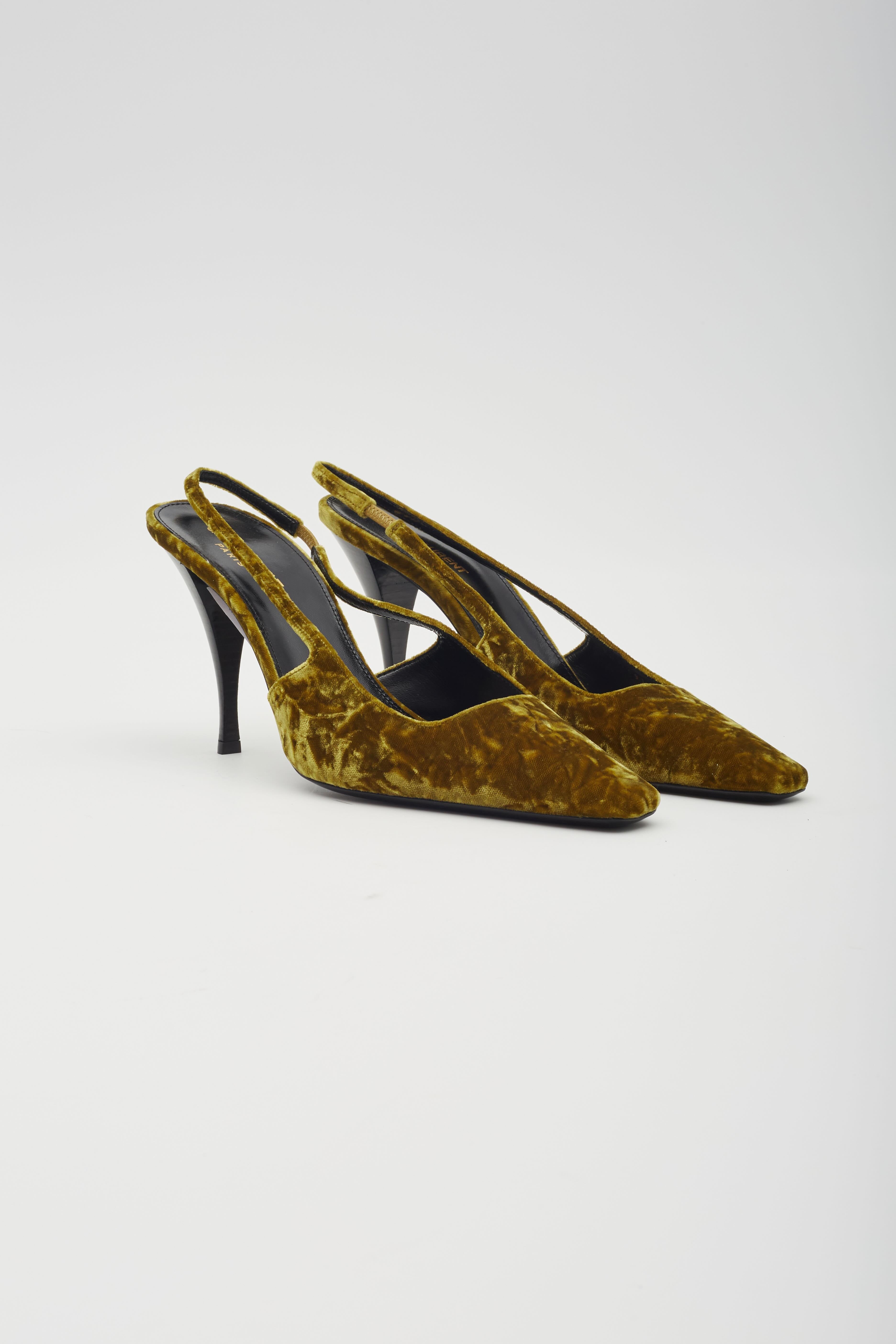 This Saint Laurent heel features a crushed velvet upper paired with a sleek leather sole. Made in Italy, the design includes a slingback style and a leather lining and footbed. The tapered toe complements the unique curved heel, which measures