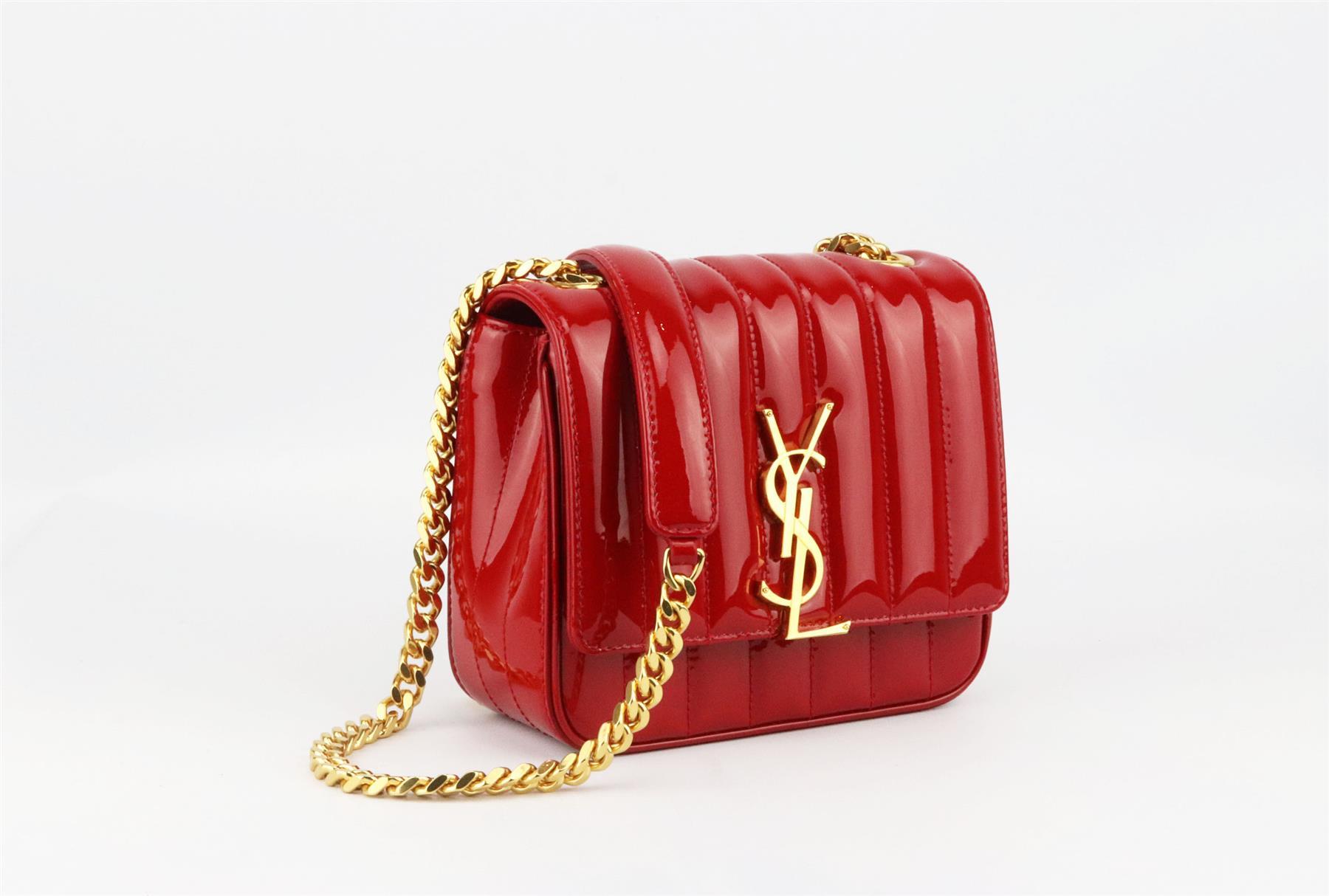 This 'Vicky' bag by Saint Laurent is made in Italy from shiny red patent-leather, this quilted accessory is decorated with the iconic 'YSL' plaque in gold to match the sliding chain strap, it also has a discreet slip pocket at the back. Red patent