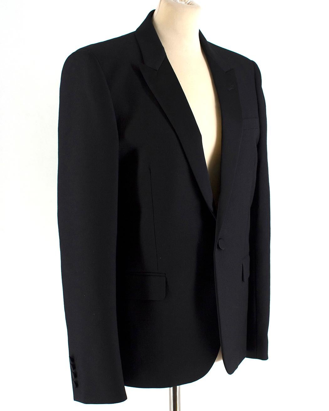 Saint Laurent Virgin Wool Le Smoking Jacket

- Modern blazer crafted in Italy from black virgin wool with a silk twill lining.
- Expertly tailored silhouette.
- A slim peak lapel with a low single-button stance.
- padded shoulders for an articulated