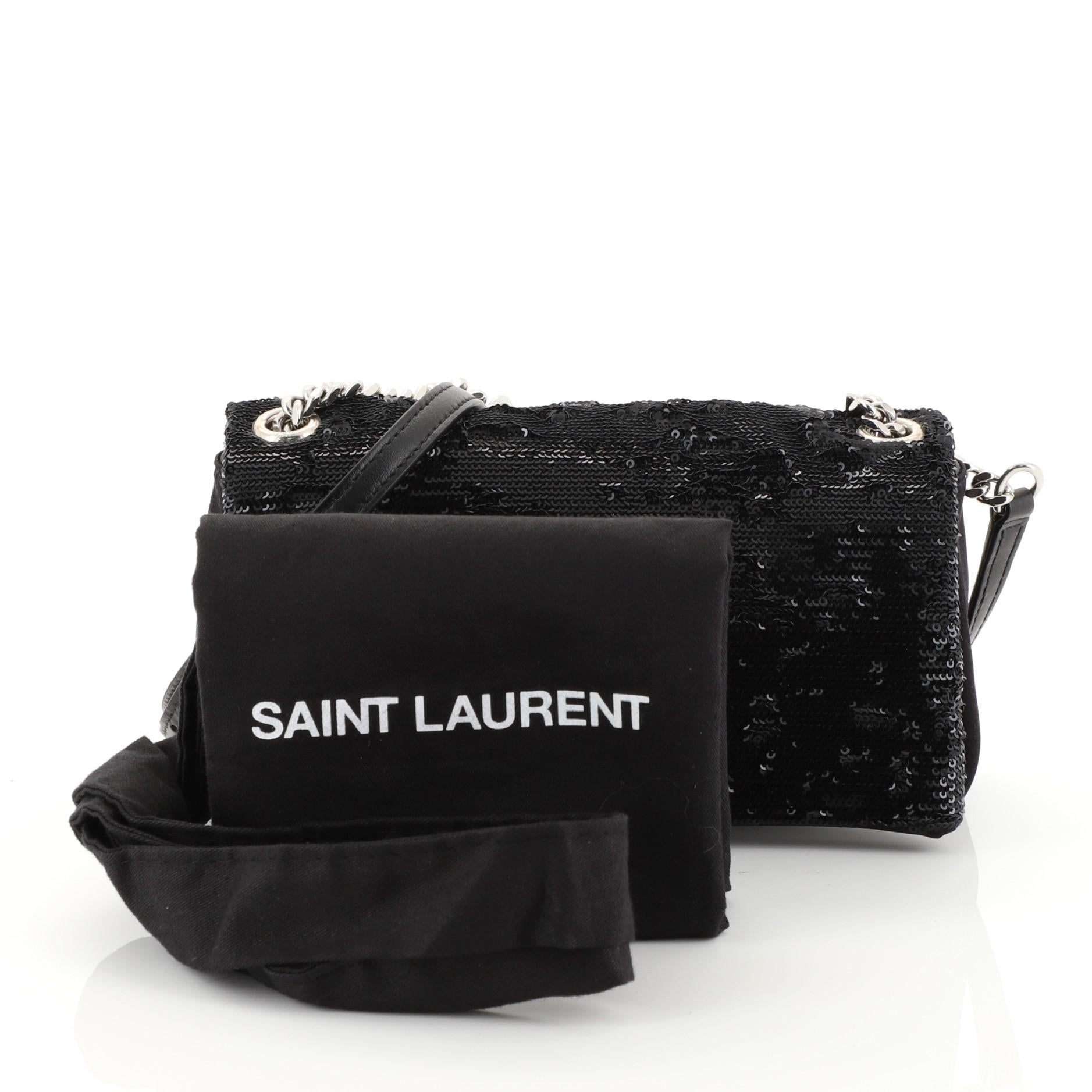 This Saint Laurent West Hollywood Crossbody Bag Sequins Toy, crafted in black sequins, features an adjustable leather and chain shoulder strap, front flap with iconic YSL logo, and silver-tone hardware. Its magnetic snap button closure opens to a