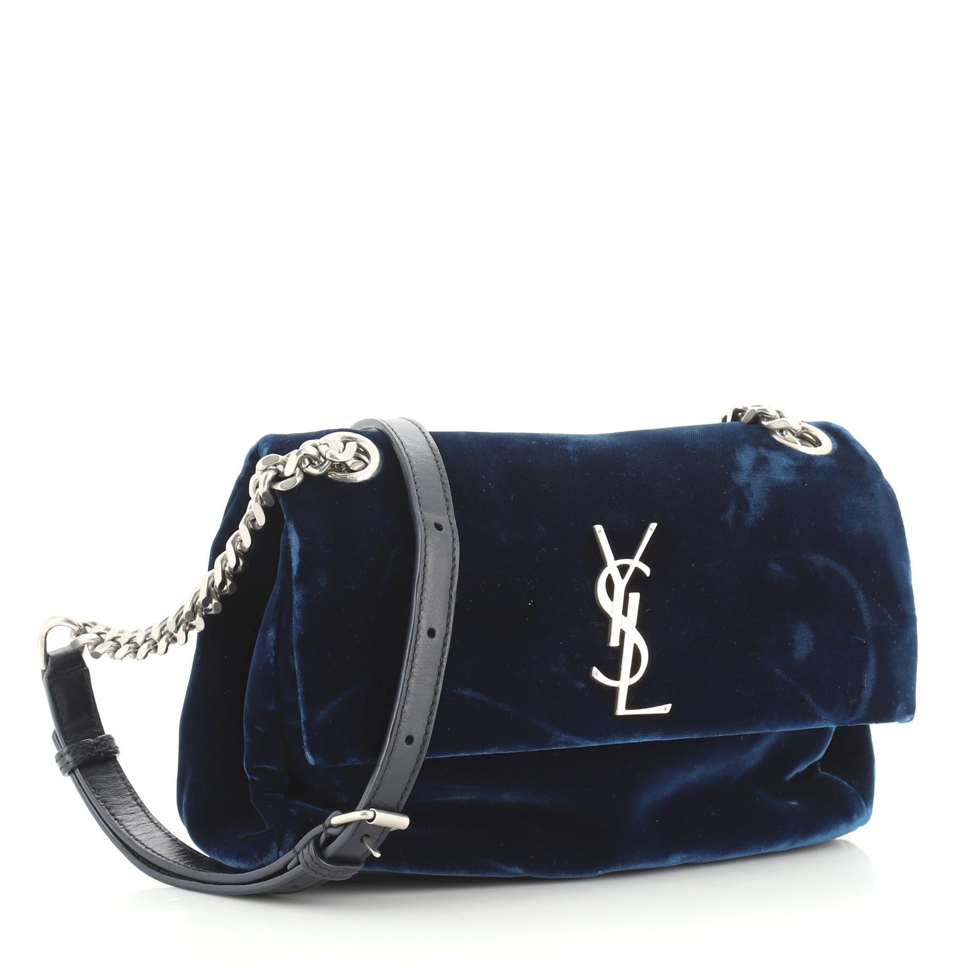 This Saint Laurent West Hollywood Shoulder Bag Velvet Small, crafted in blue velvet, features adjustable leather and chain shoulder strap, front flap with iconic YSL monogram logo and silver-tone hardware. Its magnetic snap button closure opens to a