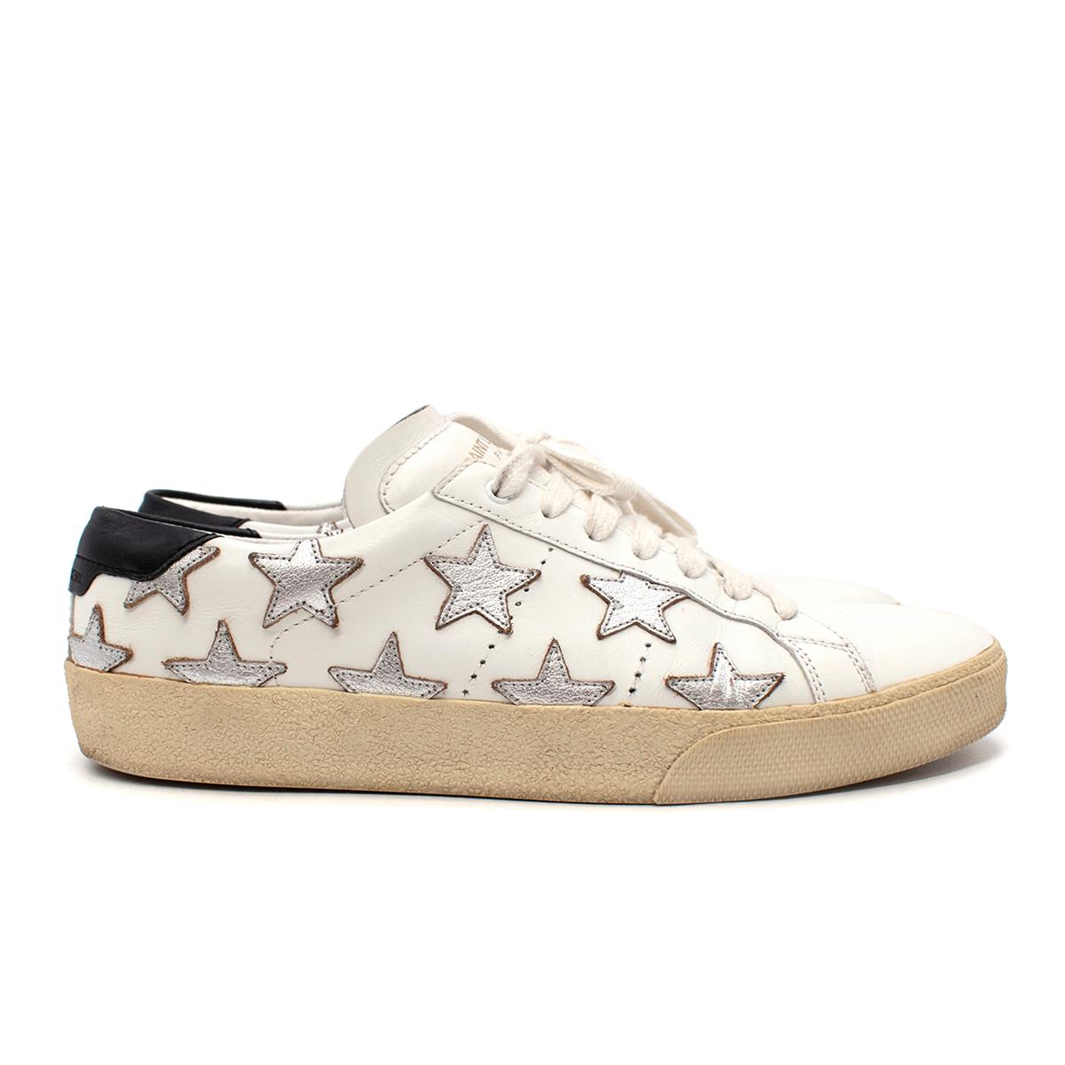 Saint Laurent White California Court Classic Star Sneakers

- Signature court-inspired sneaker by Saint Laurent featuring a thick platform rubber sole and all-white leather body decorated with metallic silver stars
- Tonal white elasticated laces
-
