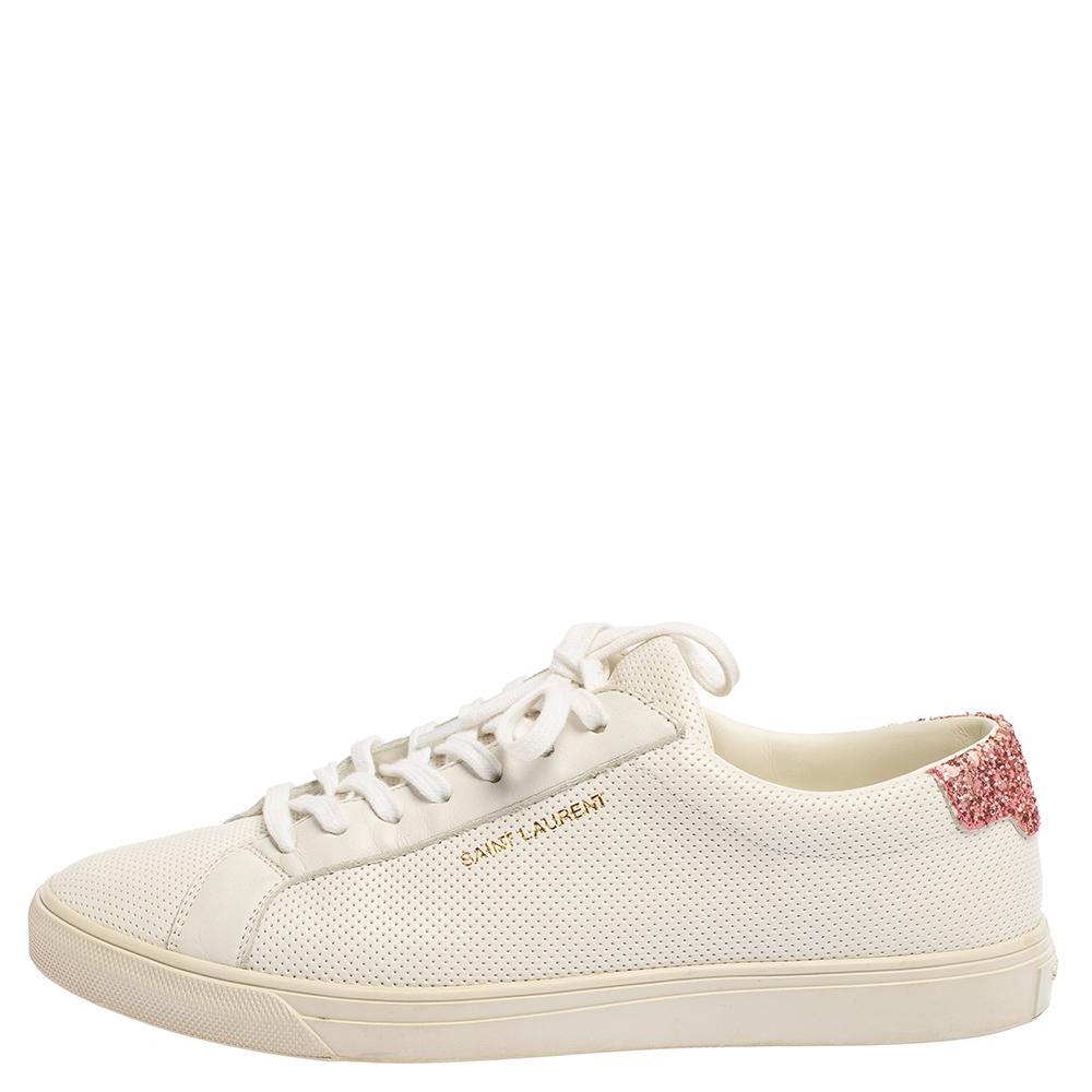 These Andy low-top sneakers from Saint Laurent are designed keeping minimal aesthetics in mind. They are crafted from white leather and to add a glamorous vibe to them, the counters are sprinkled with glitter. They feature round toes, lace-ups on