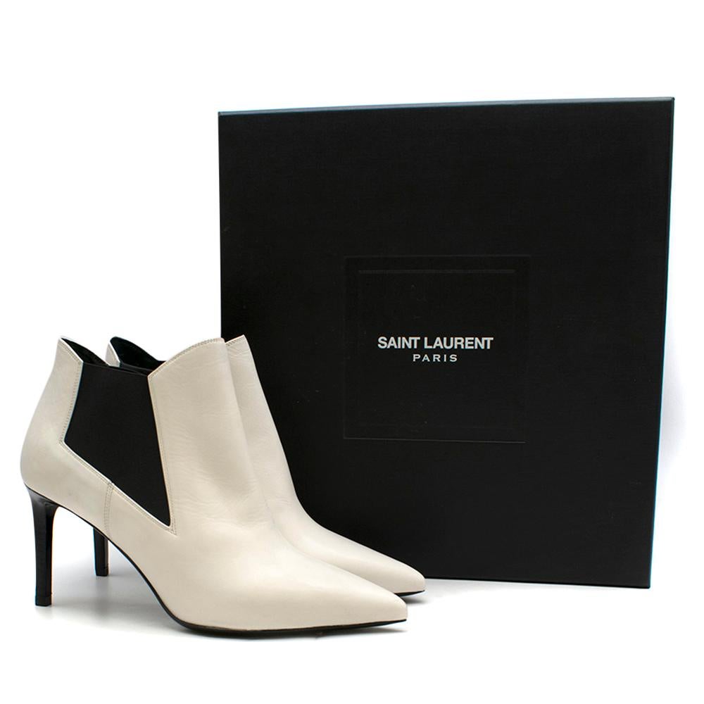 Saint Laurent White Leather Ankle Boots

- Off-white leather
- Point toe, contrasting black leather high heel
- Pull on
- The elasticated black side panels make them easy to slip on and off.
- Made in Italy
-Comes with additional heel tips.

Please