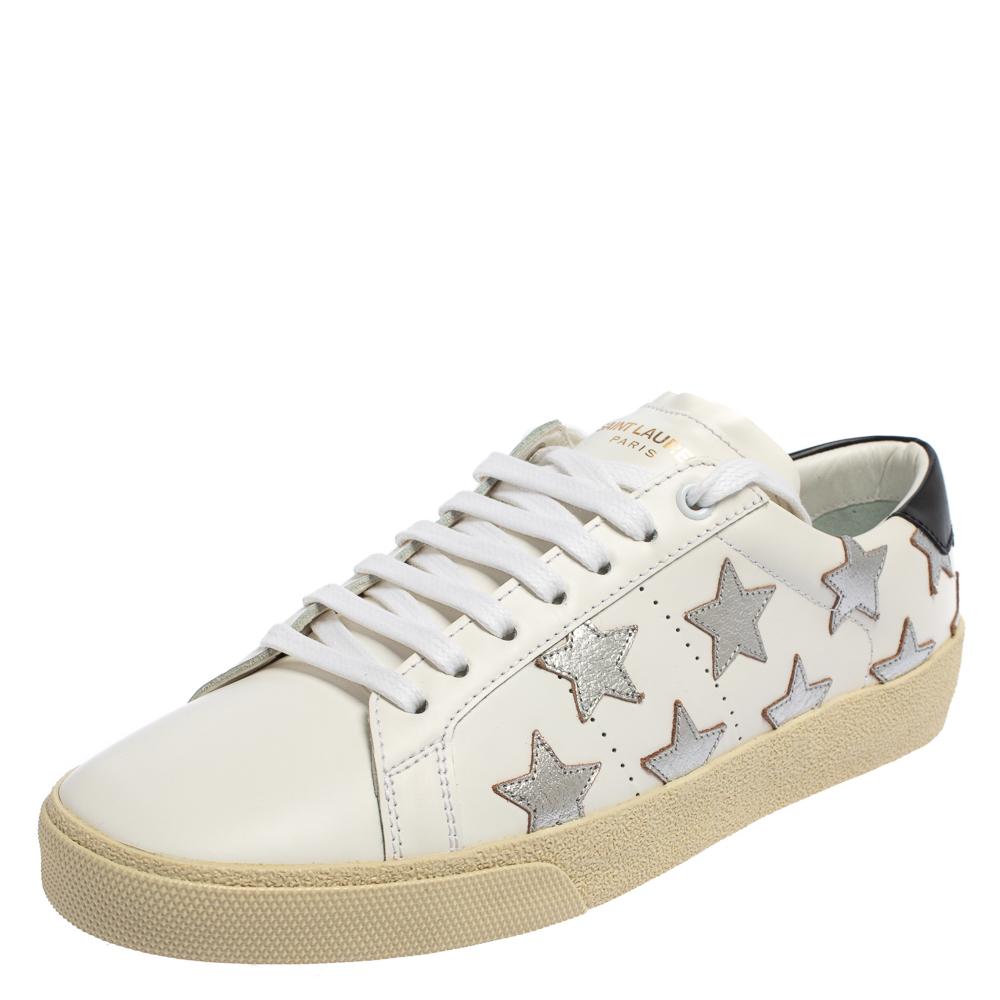 Comfort and style come together in these stylish low-top sneakers from Saint Laurent. These have been crafted from white leather and styled with round toes, lace-ups on the vamps, star patches on the sides, logo details on the counters, and durable