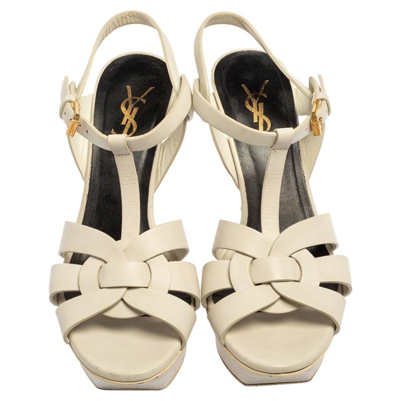 One of the most sought-after designs from Saint Laurent is their Tribute sandals. They are such a craze amongst fashionistas around the world, and it is time you own one yourself. These white ones are designed with leather straps, ankle fastenings