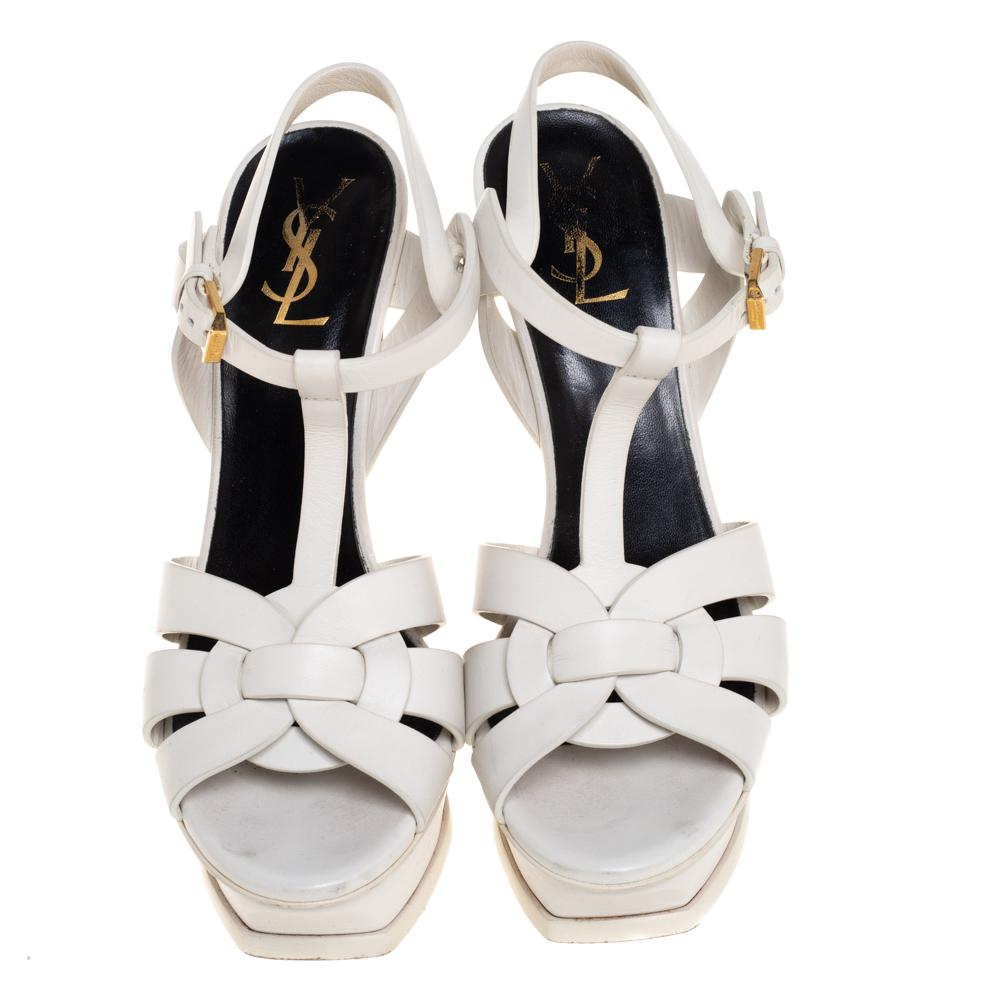 One of the most sought-after designs from Saint Laurent is their Tribute sandals. They are such a craze amongst fashionistas around the world, and it is time you own one yourself. These white ones are designed with leather straps, ankle fastenings,